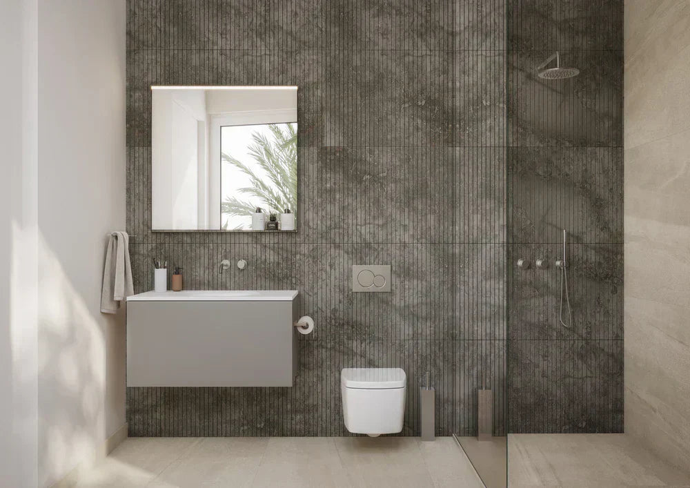 Modern luxury bathroom with a floating vanity, walk-in glass shower and textured stone wall tiles.