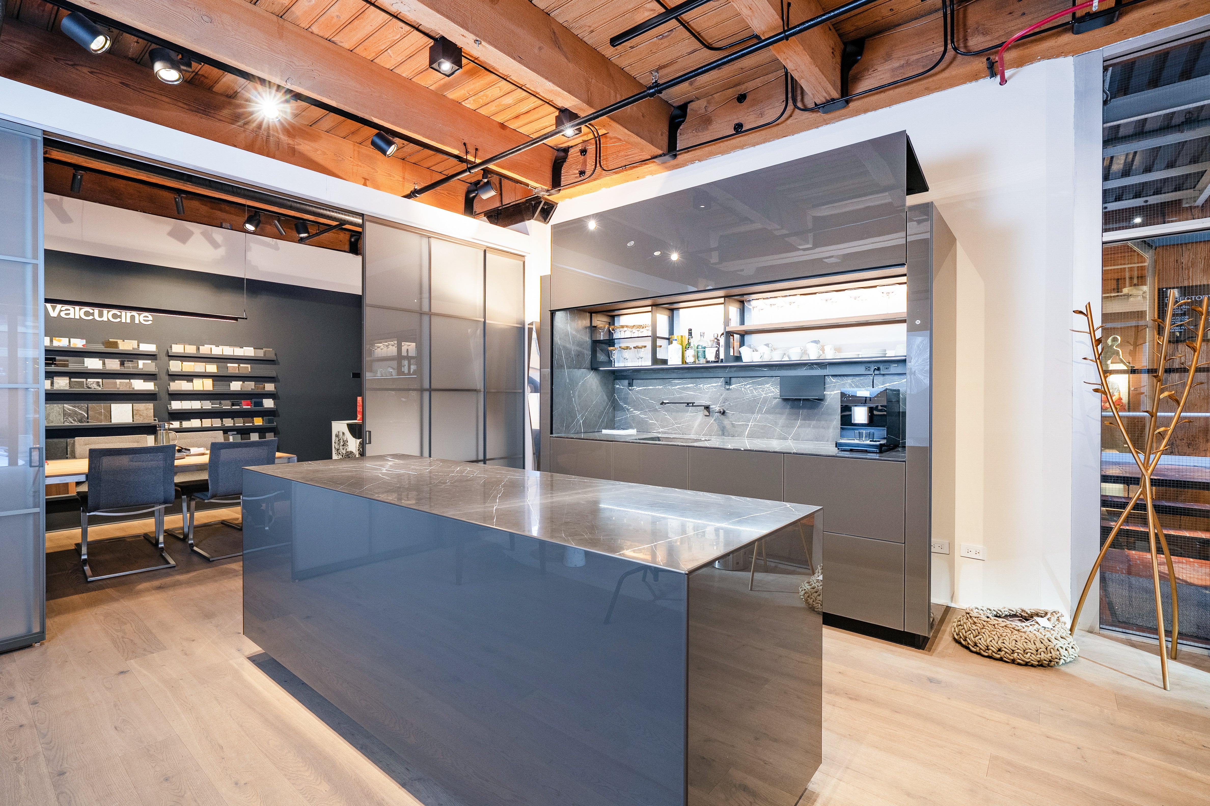 Luxury wet bar cabinets and kitchen island with integrated storage in a modern showroom