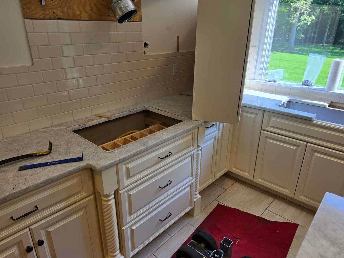 Aurora Circ traditional light cream kitchen cabinets with raised panel doors granite countertops and subway tile backsplash under installation