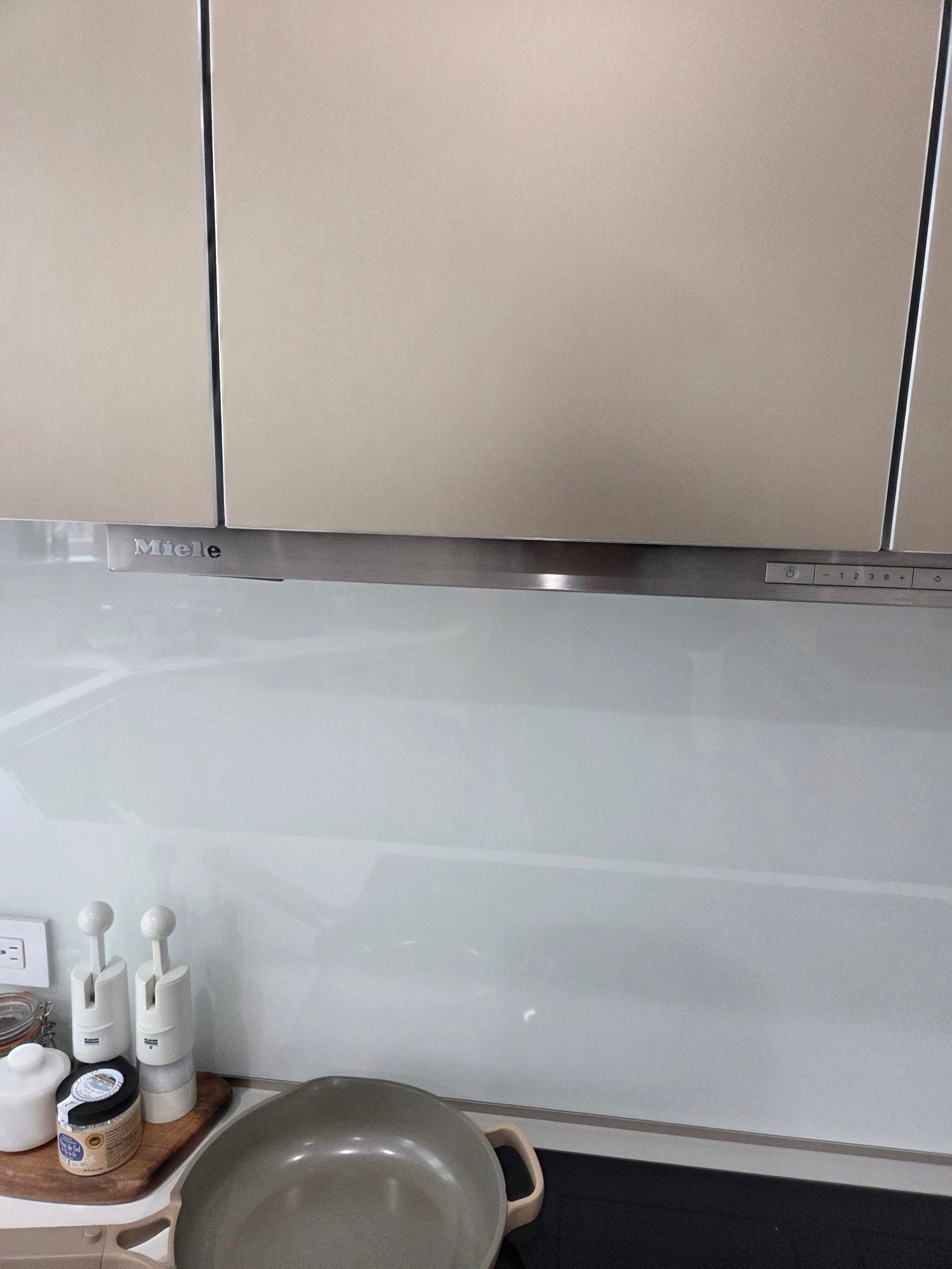 Bulthaup Modern Metallic Bronze Upper Cabinets with Glass Backsplash and Miele Hood Insert