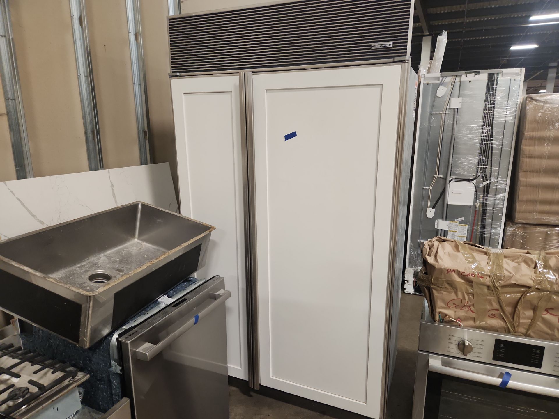 “The Westerly” Transitional White Kitchen with Island, 48" Sub-Zero Refrigerator and Bosch Appliances
