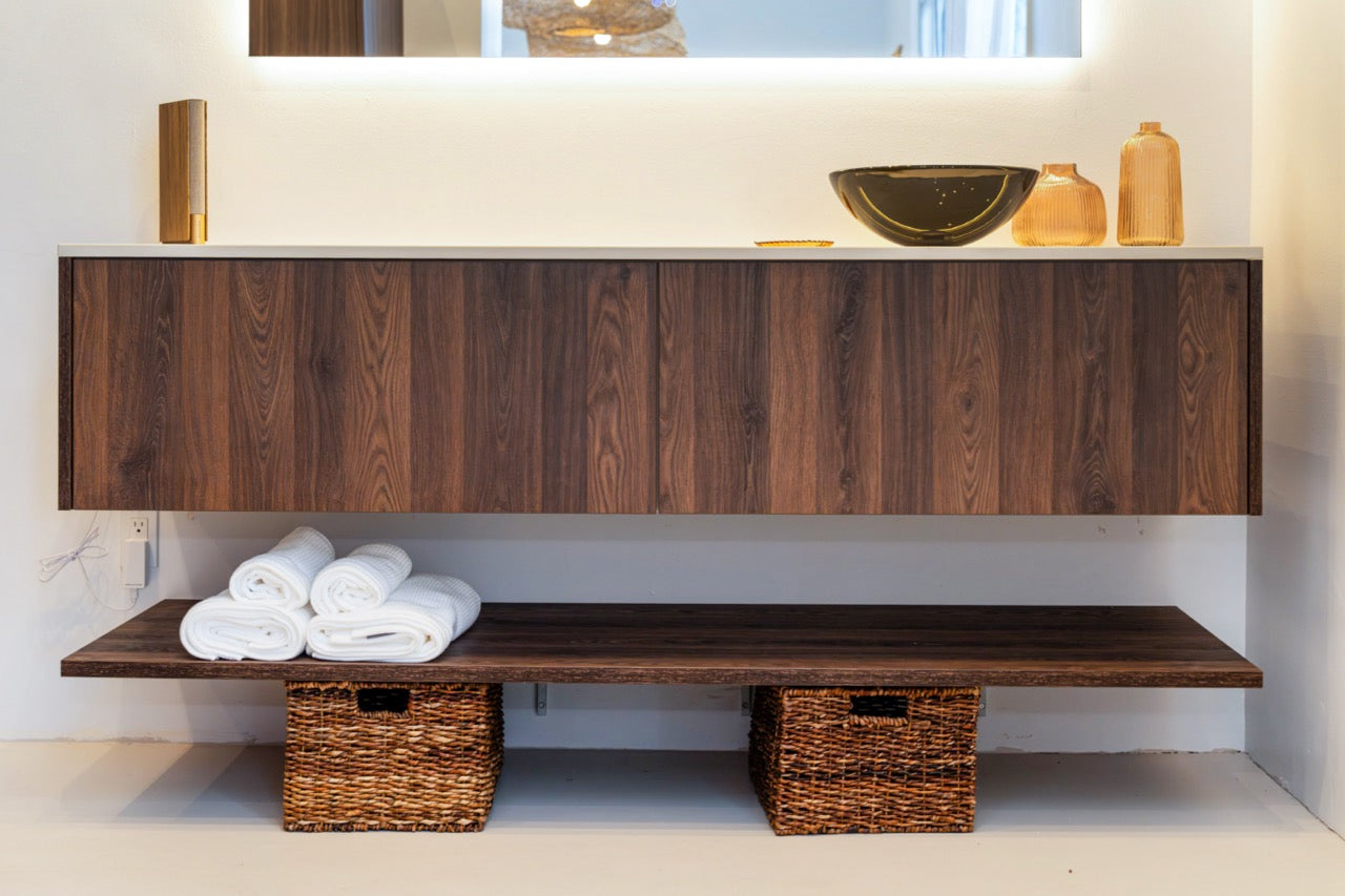 Luxury German wall mounted handleless vanity showing continuous book matched wood grain across drawers