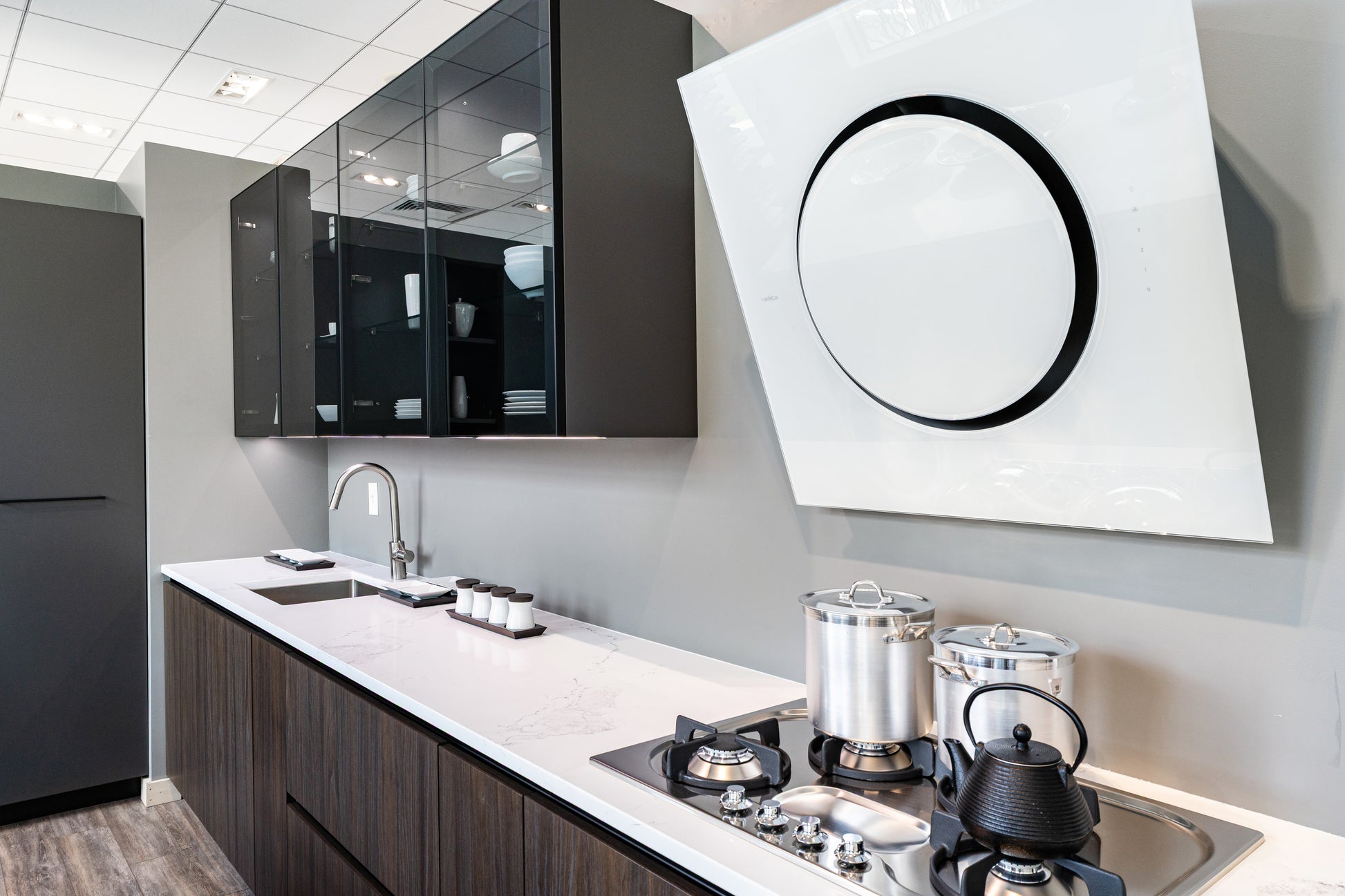 Luxury custom Italian handleless kitchen package showing matte charcoal and soft cream lacquer doors with base drawers open