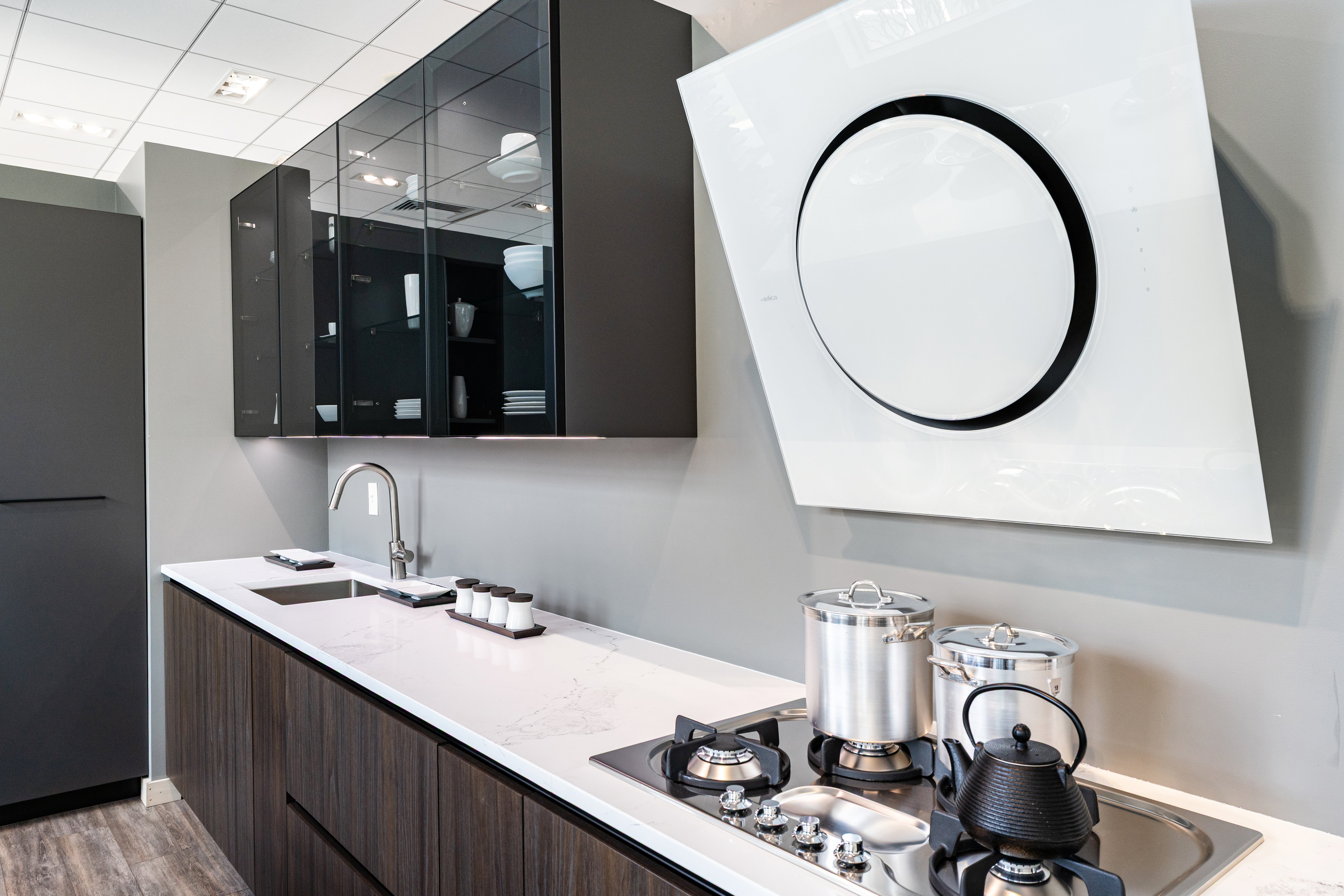 Luxury custom Italian handleless kitchen package showing matte charcoal and soft cream lacquer doors with base drawers open