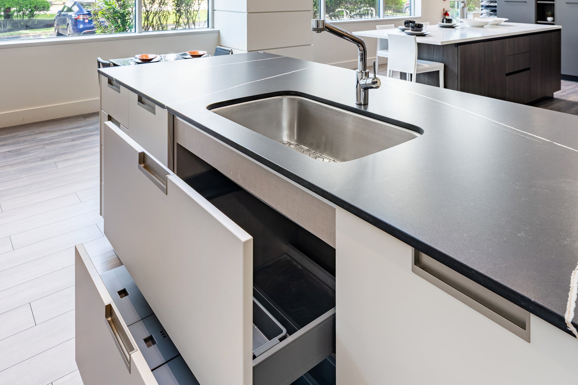 Luxury custom Italian handleless kitchen package showing burnished metallic finish island drawers and pan storage open