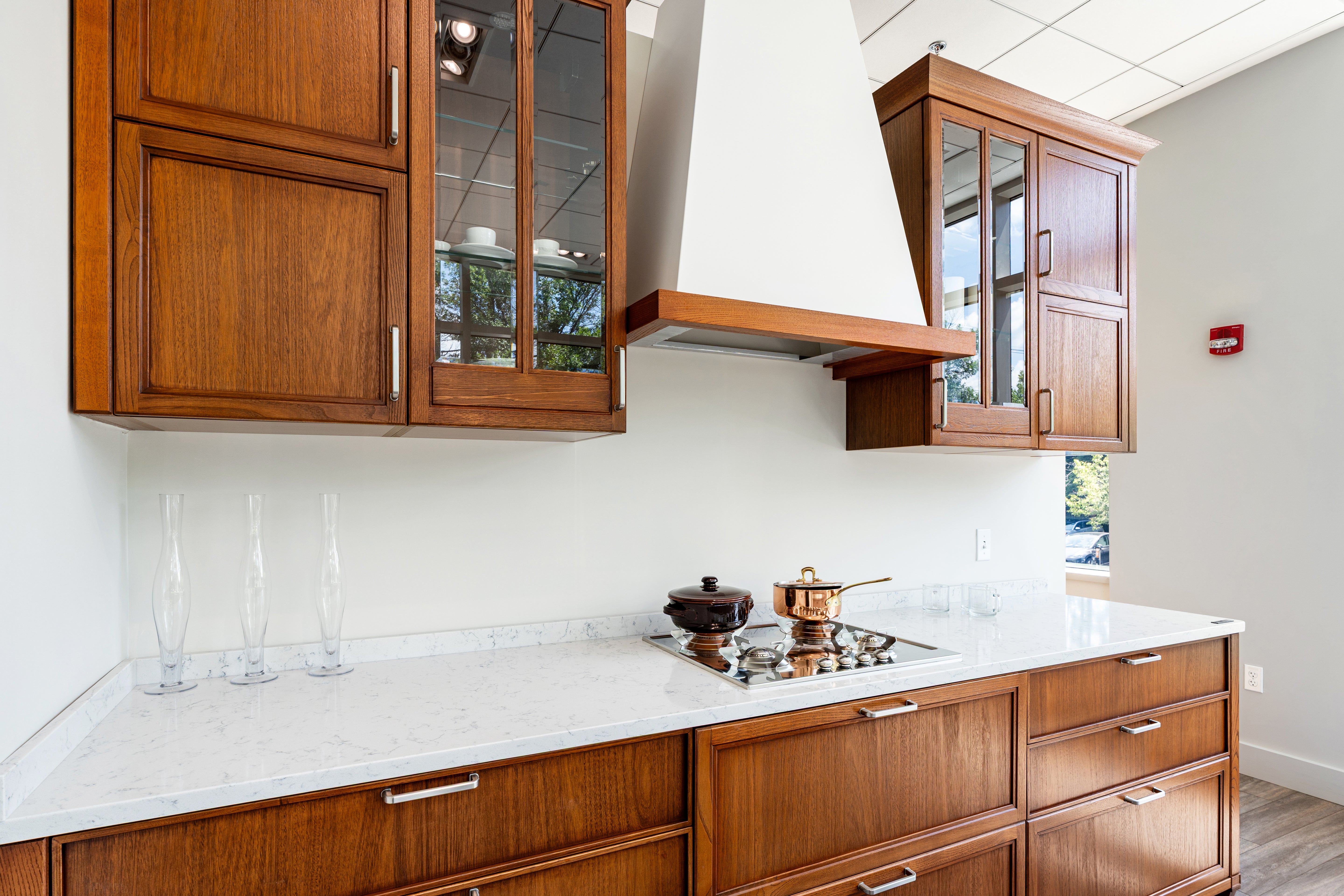Aster Cucine white kitchen layout featuring integrated cabinet paneled appliances and crown molding