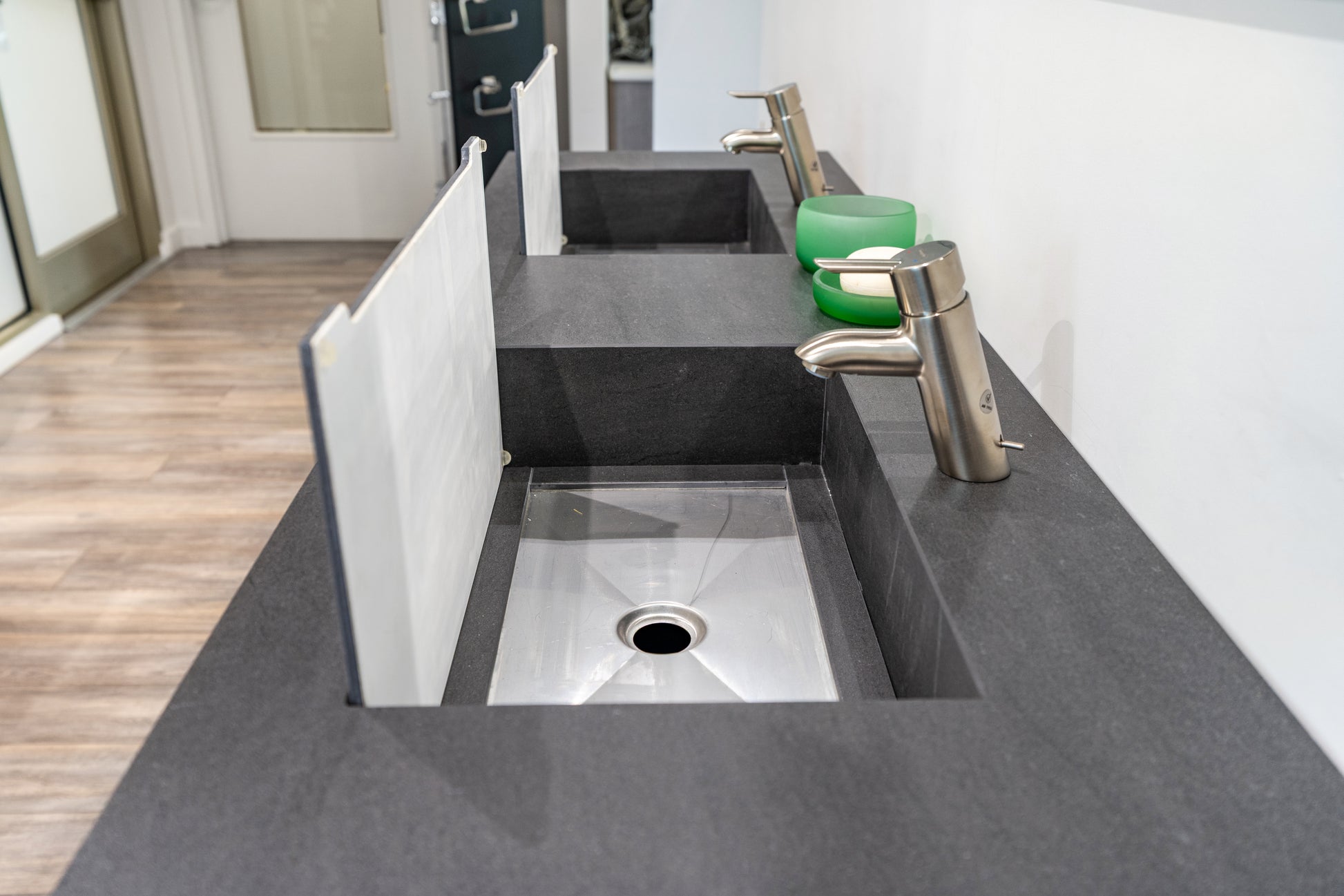 Luxury wall mounted modern grey double bathroom vanity open showing push to open drawers with custom plumbing cutouts