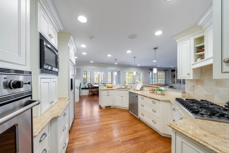 Luxury white kitchen suite with side pantry and stone countertops