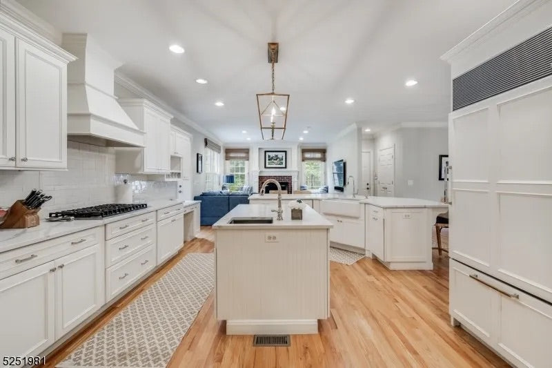 Luxury modern white shaker kitchen cabinets open showing integrated premium appliances