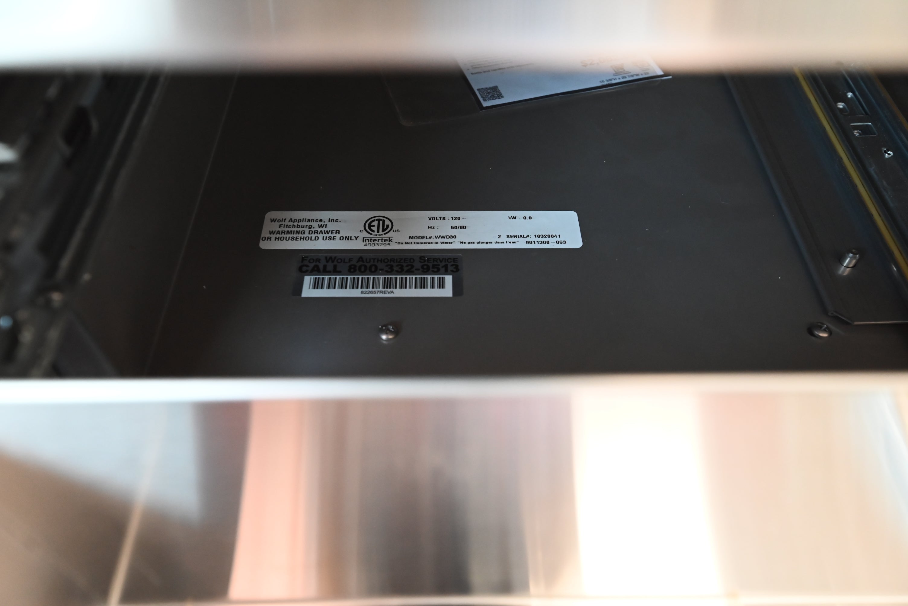 Wolf 30 warming drawer open showing full extension racks and hidden digital controls