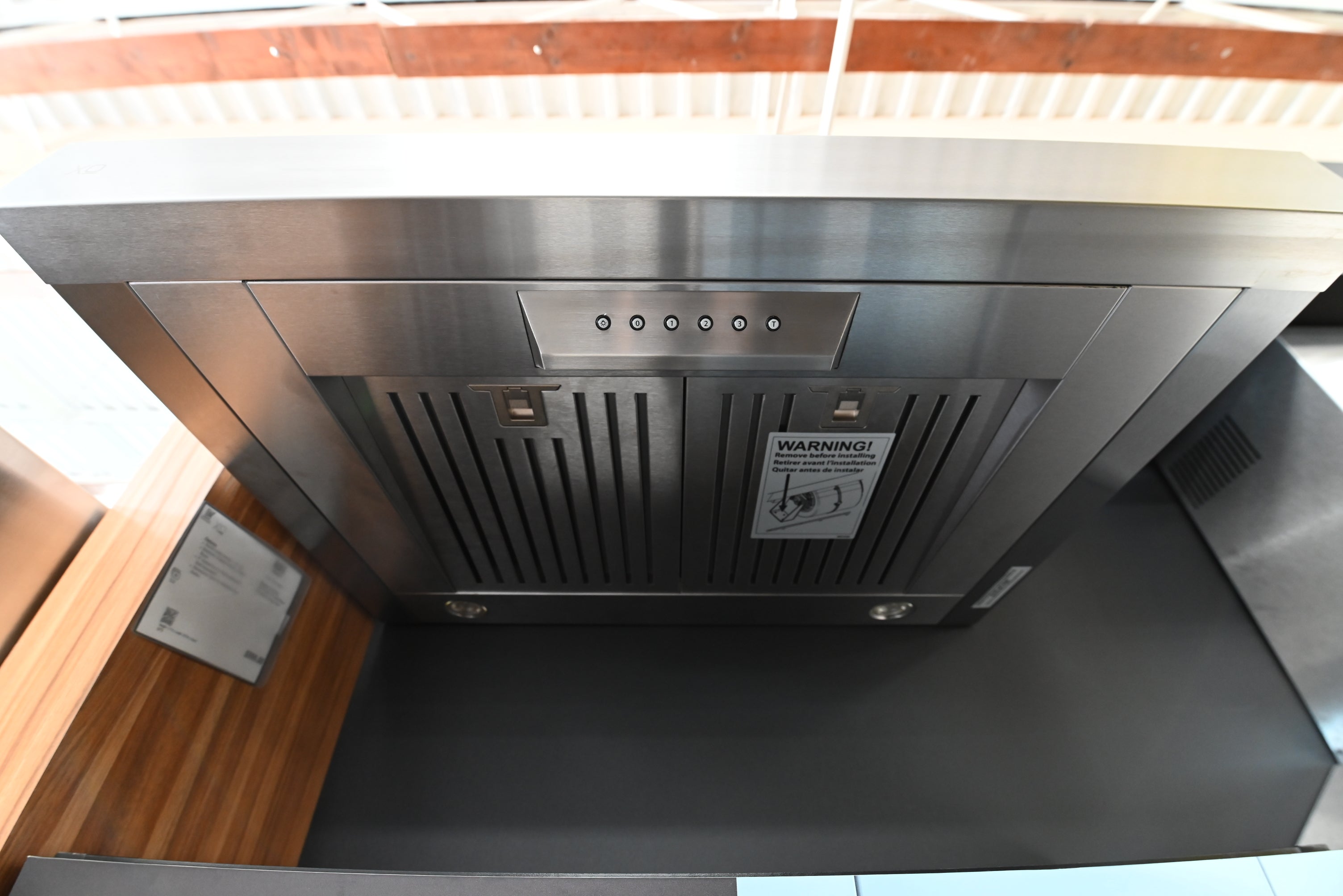 Close up of slide out visor and aluminum mesh filters on XO 30 inch range hood