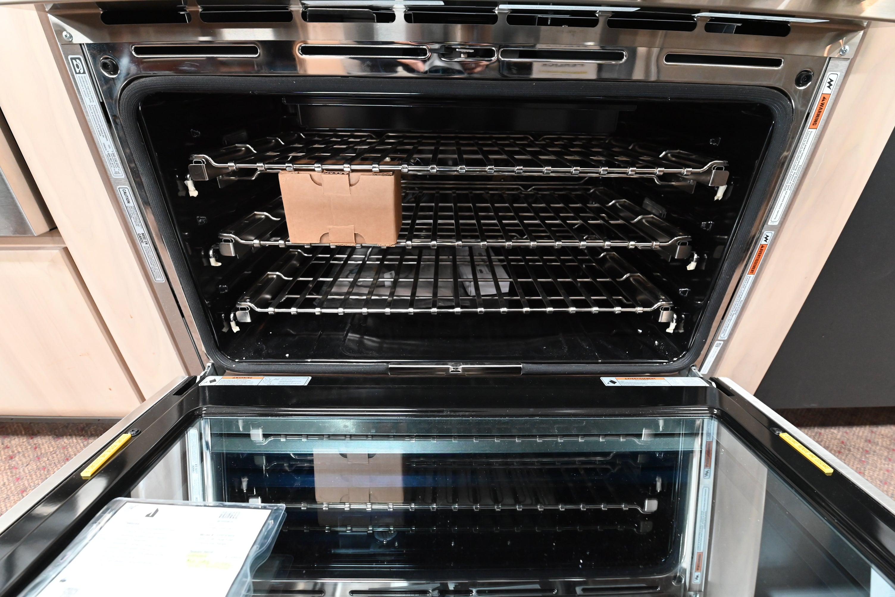 JennAir RISE 36 inch pro range open door showing large convection oven cavity with theater LED lighting