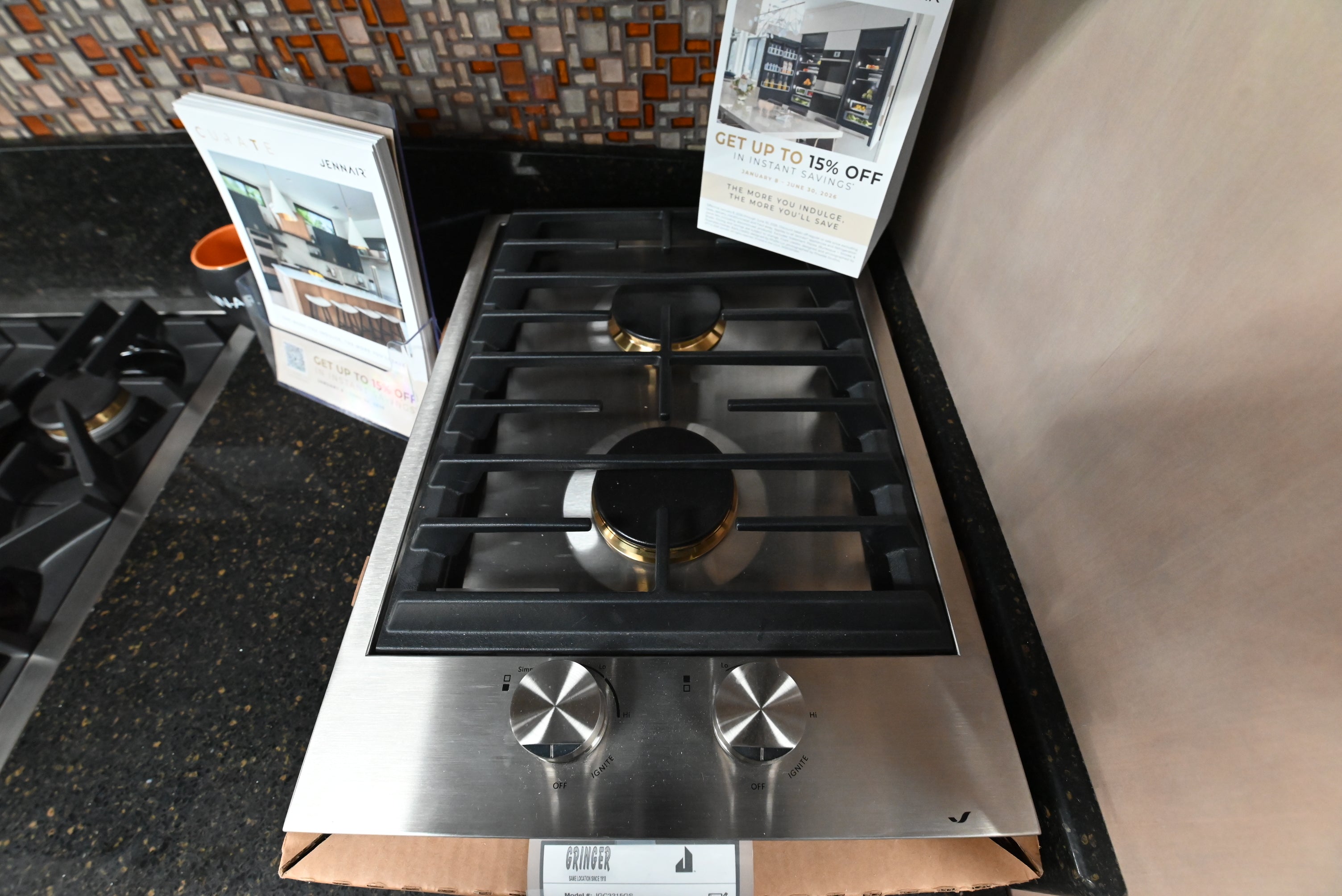 Luxury modular 15 inch cooktop showing heavy duty brass burners and matte black cast iron grate