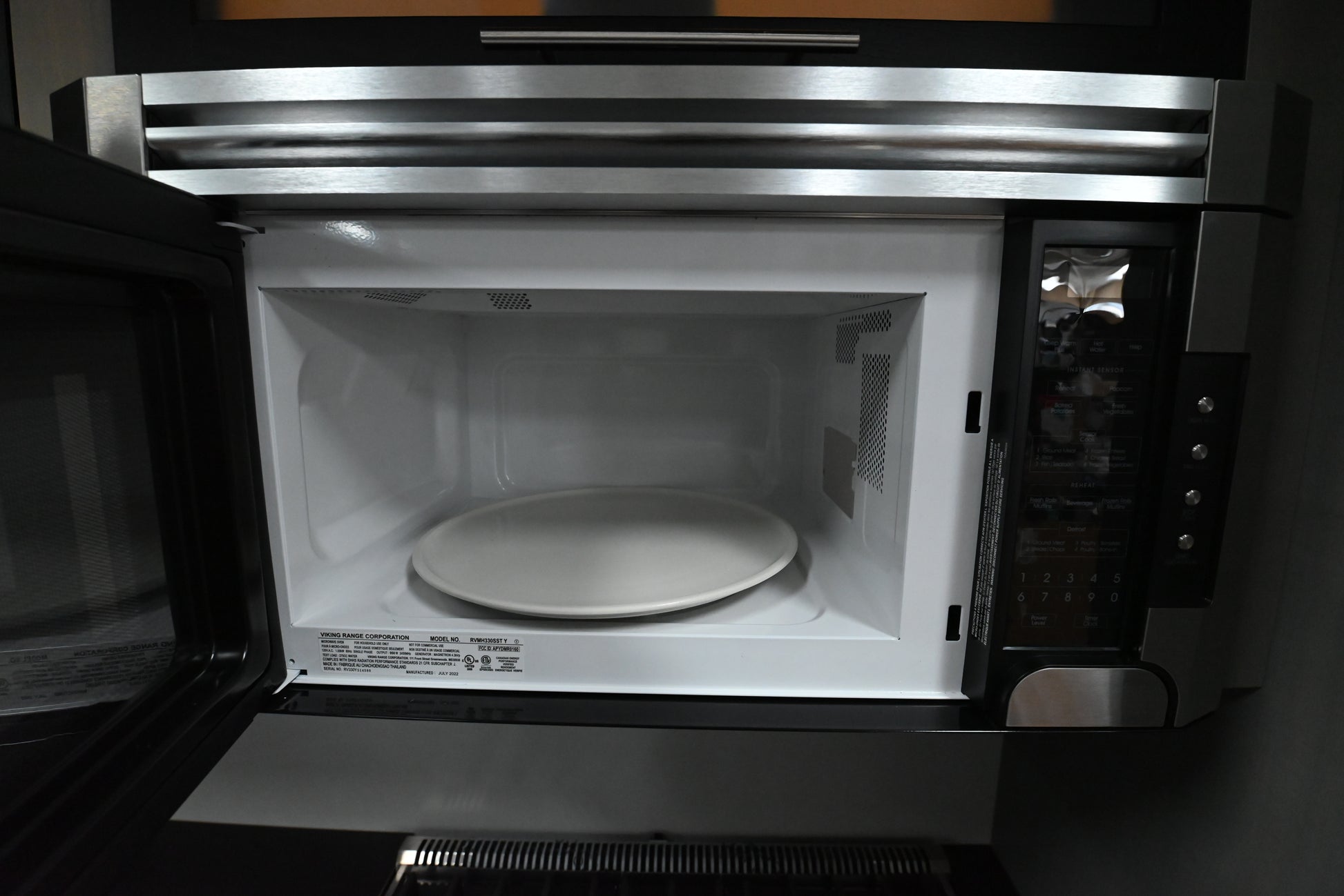 Luxury 30 inch over the range microwave showing pro style stainless handle and right touch control pad
