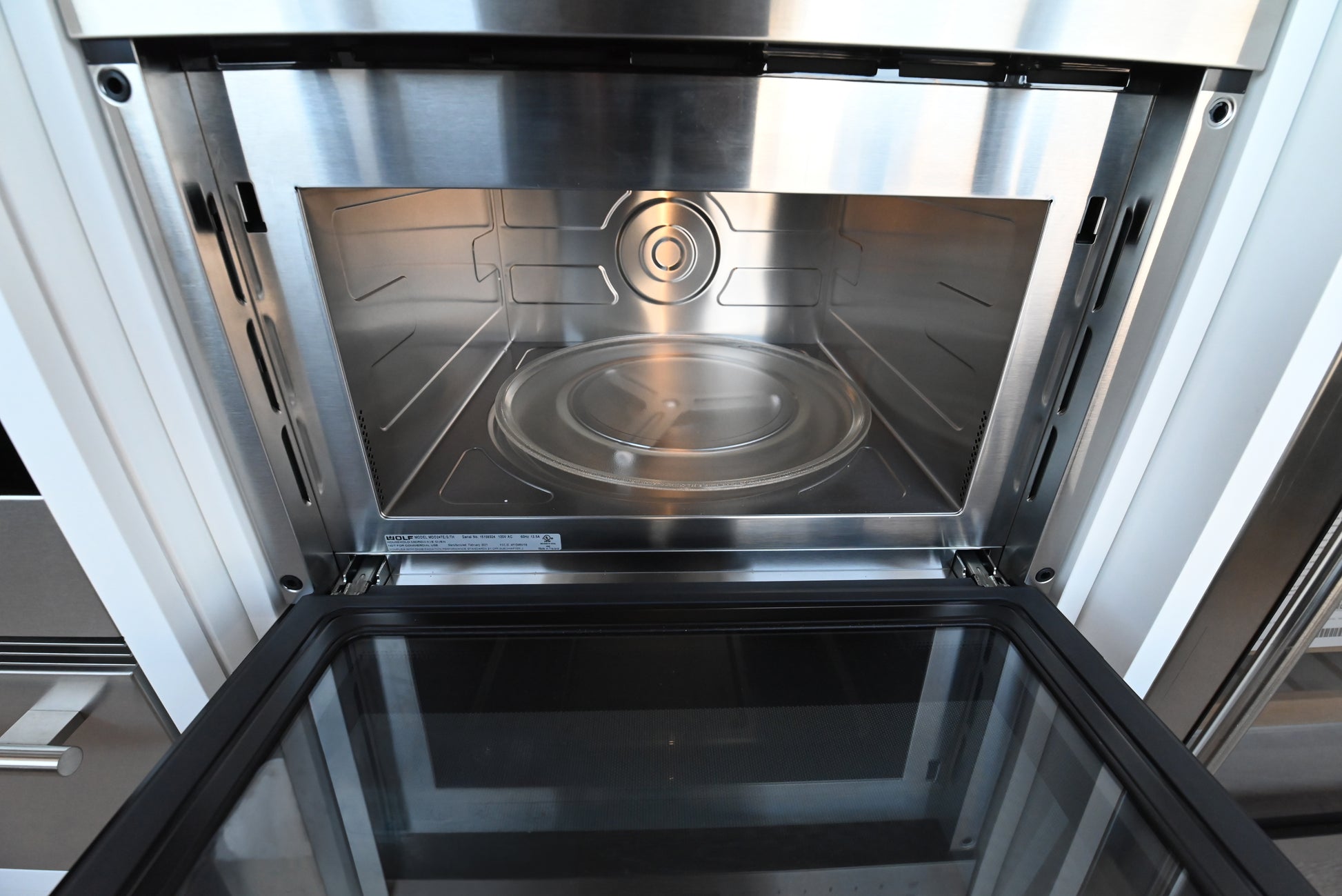 Luxury under counter 24 inch microwave drawer by Wolf showing motorized door glides open