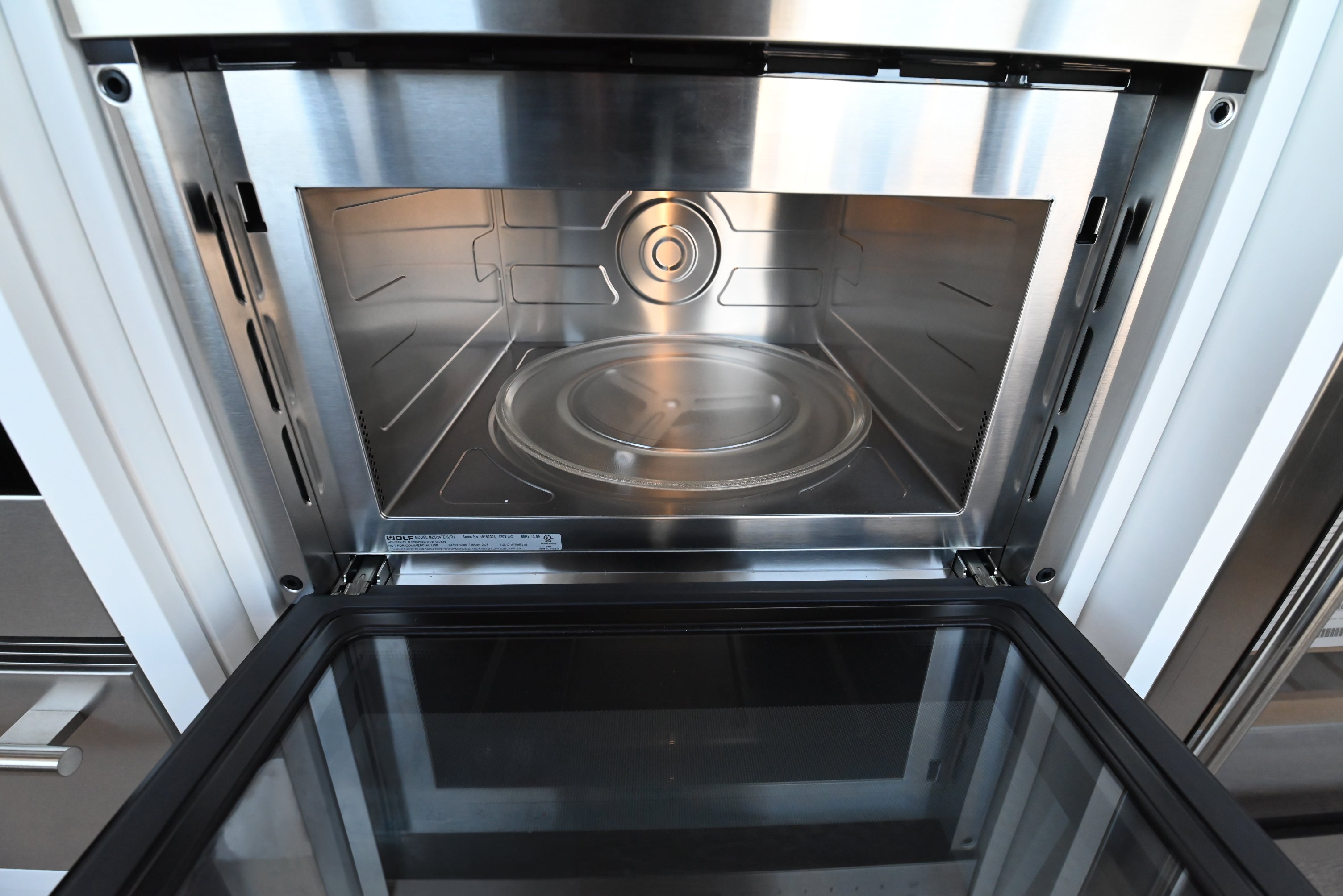 Luxury under counter 24 inch microwave drawer by Wolf showing motorized door glides open