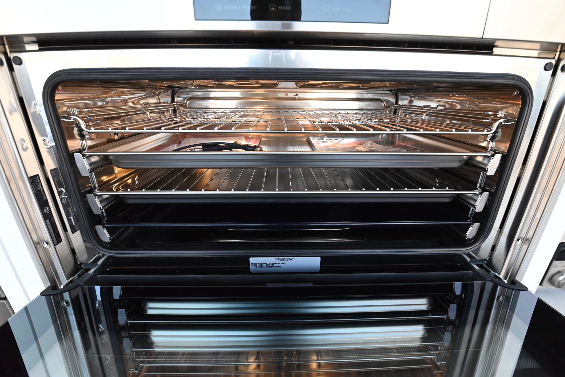 Wolf convection steam oven open showing multi tier racks and stainless steel interior cavity