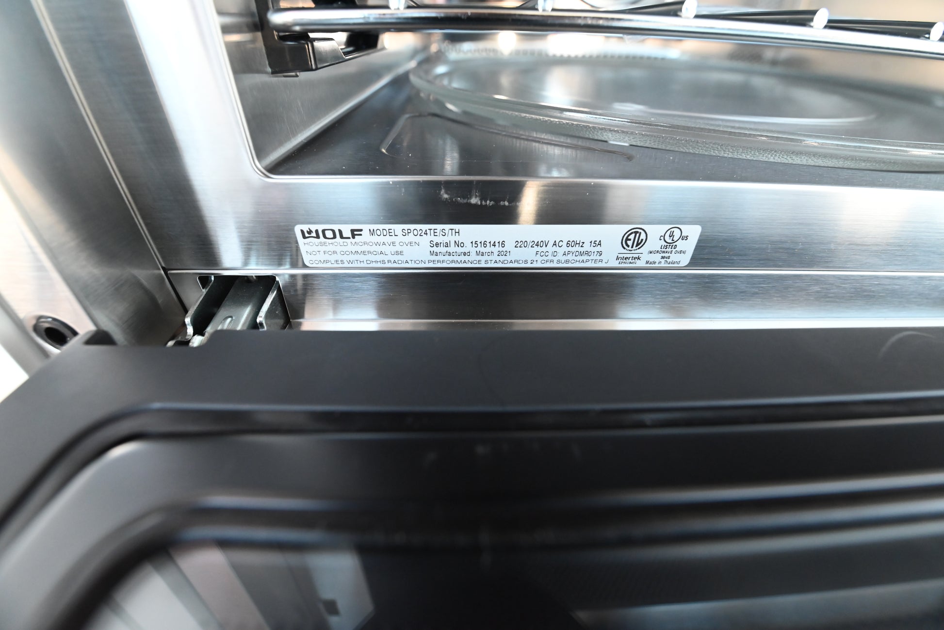 Wolf 24 inch speed oven showing open door and premium stainless interior cavity