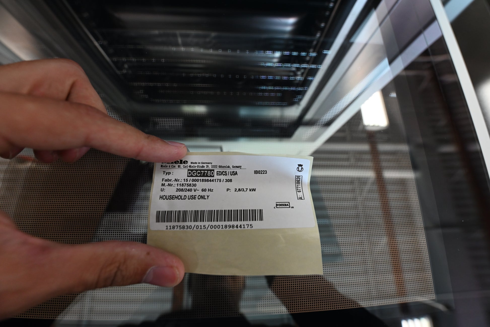 Miele XXL combi steam wall oven showing open door stainless interior shelves