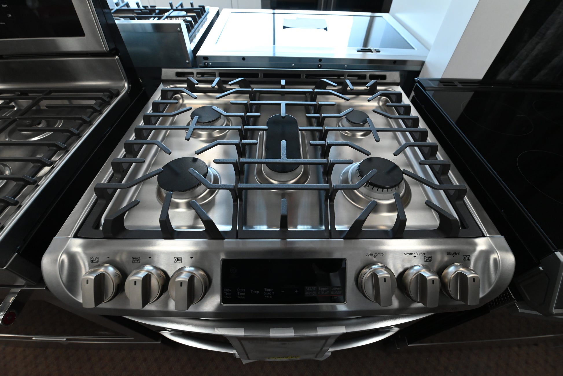 Close up of LG LTG4715ST angled front knobs and SmoothTouch glass controls