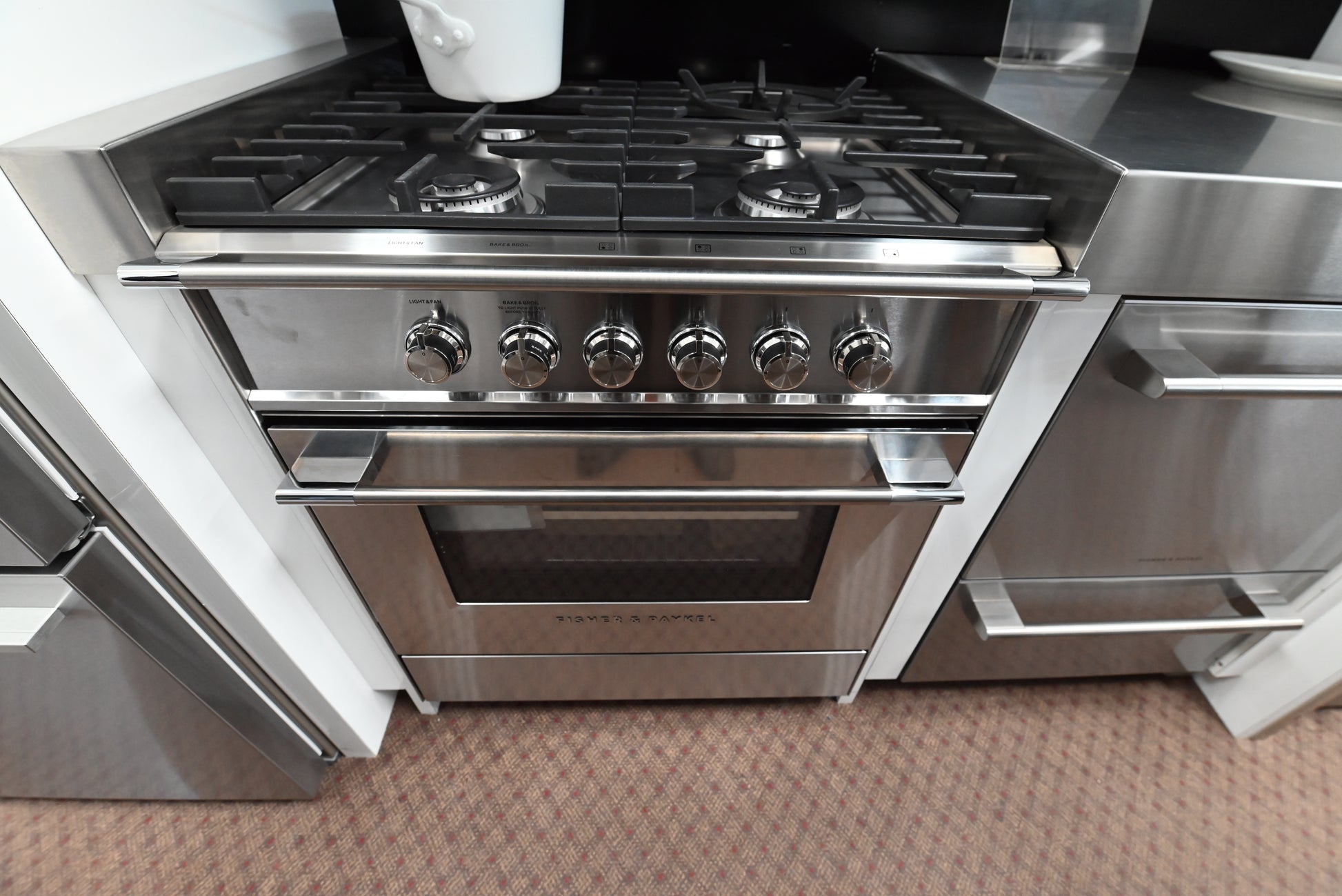 Close up of Fisher and Paykel Series 7 classic control knobs and oven door