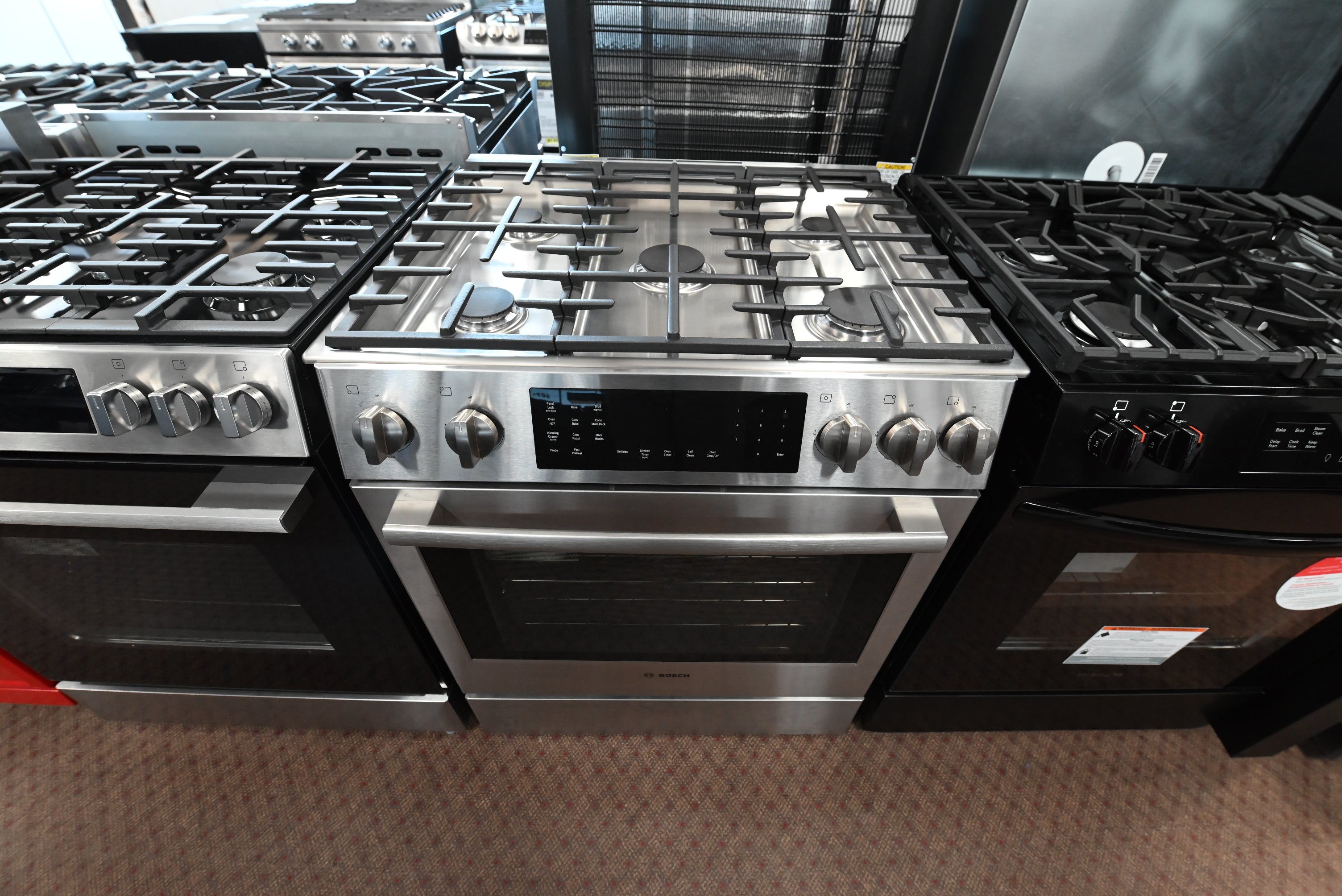 Luxury 30 inch integrated dual fuel range open showing oven interior racks and meat probe