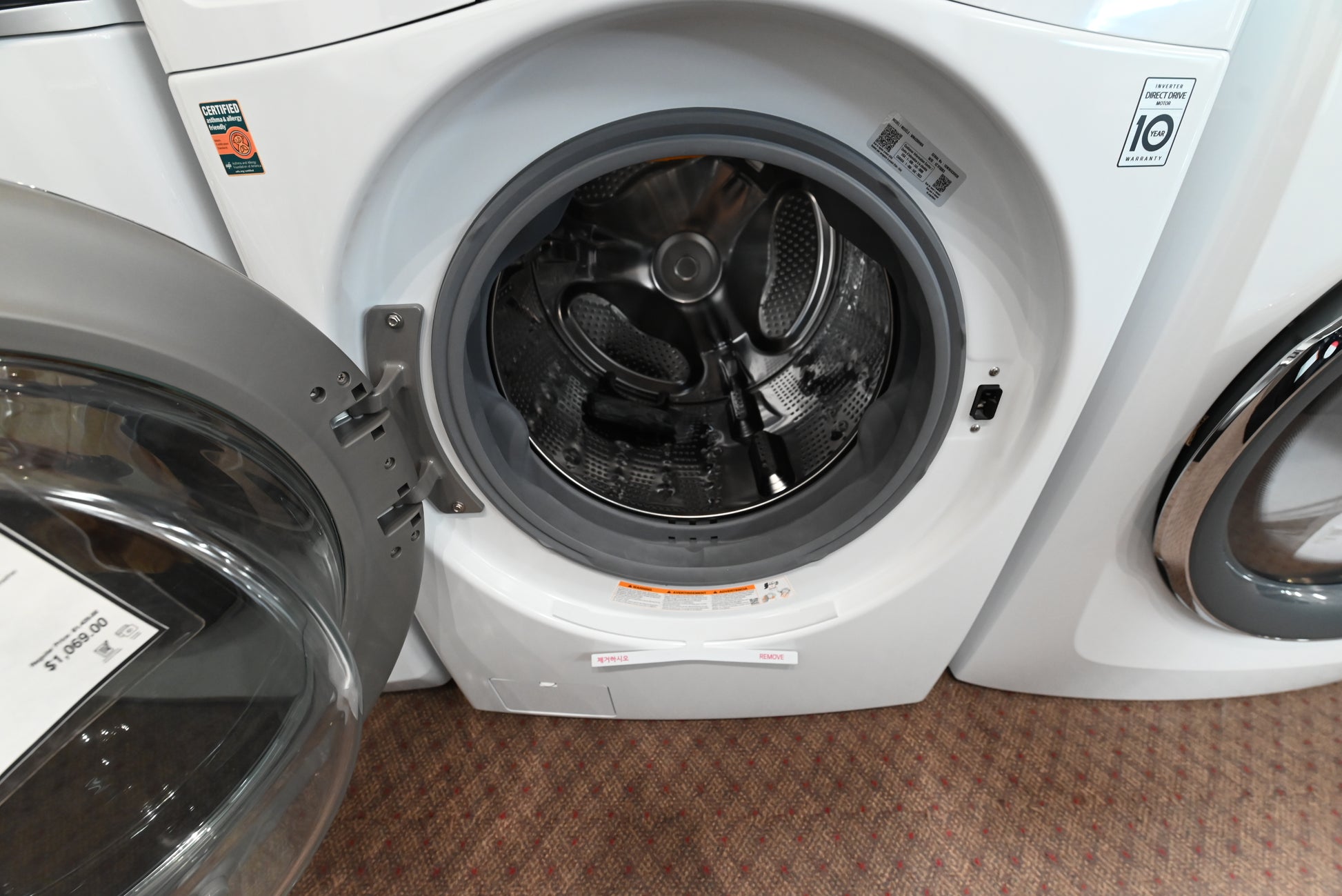 Luxury 27 inch front load washing machine showing clear tempered glass door and interior stainless steel tub