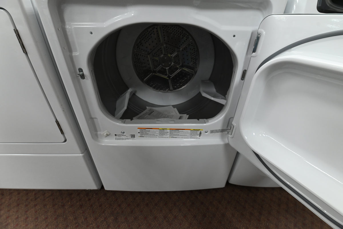 Close up view of the electromechanical control knobs and 5 year warranty label on the GE GTX52GASPWB dryer