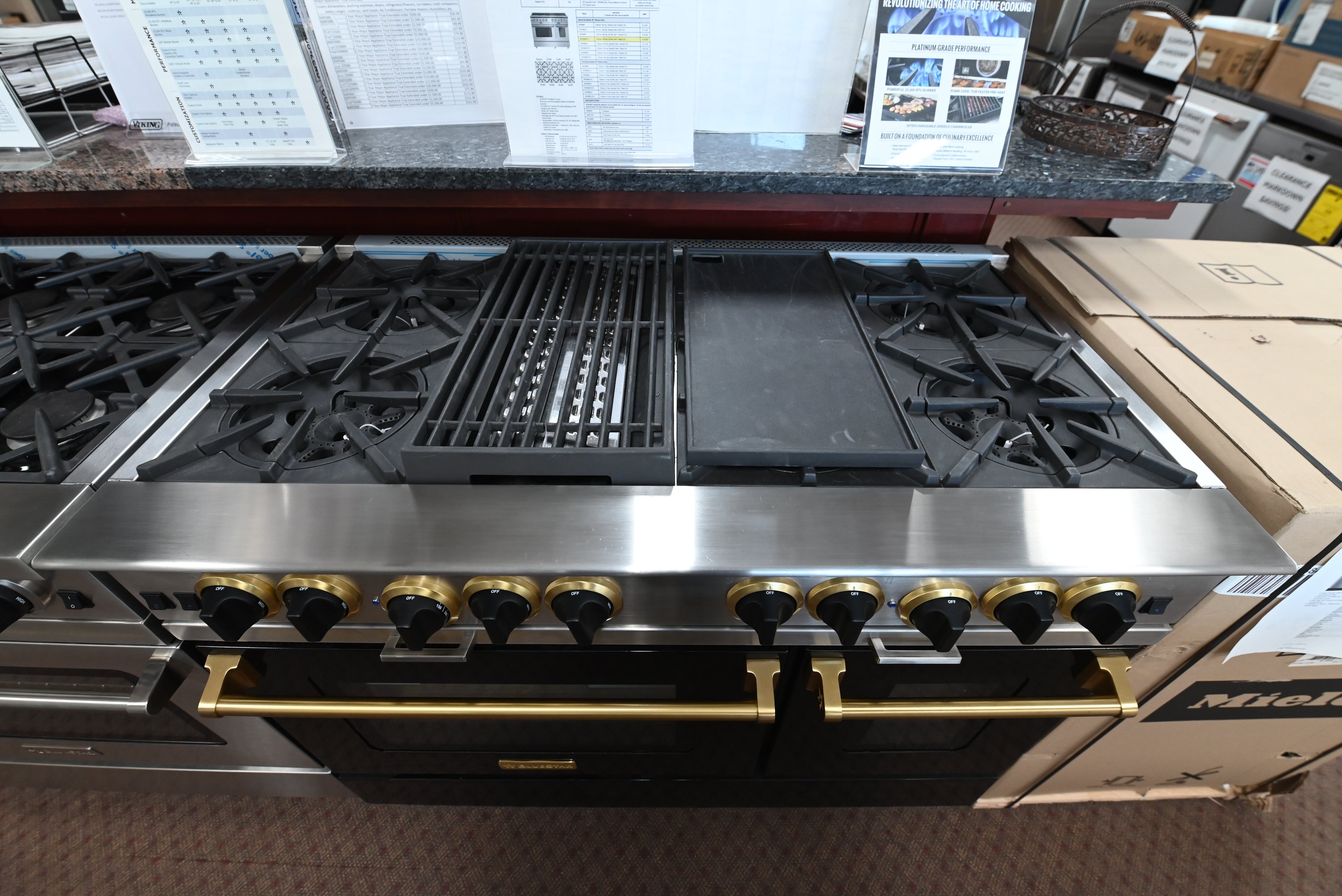 Luxury 48 inch black gas range with 8 open burners and polished brass knobs by BlueStar