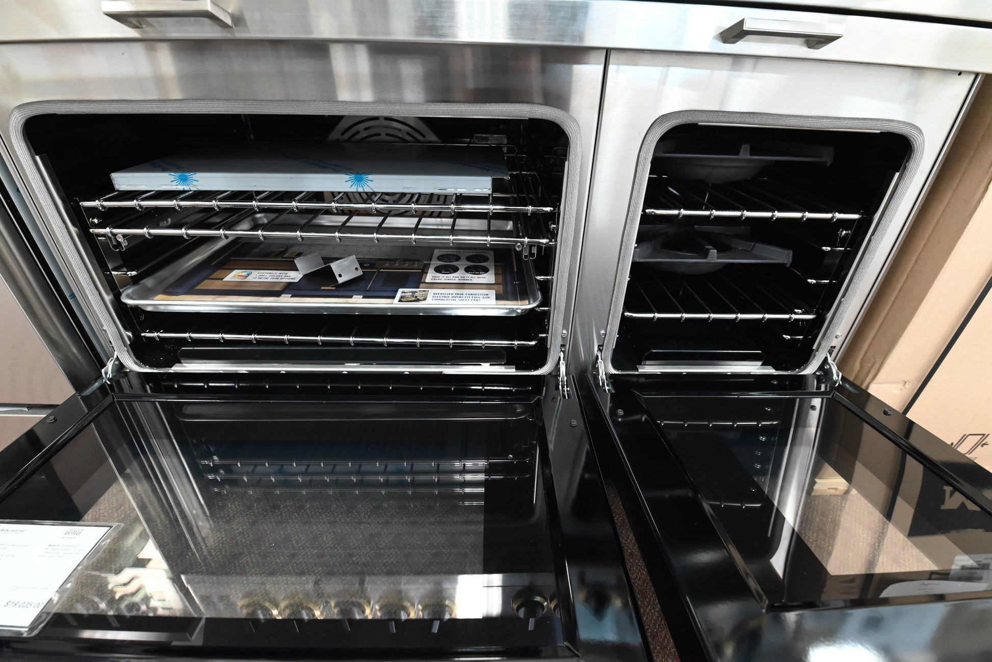 BlueStar 48 range showing open twin convection doors and commercial cast iron grates