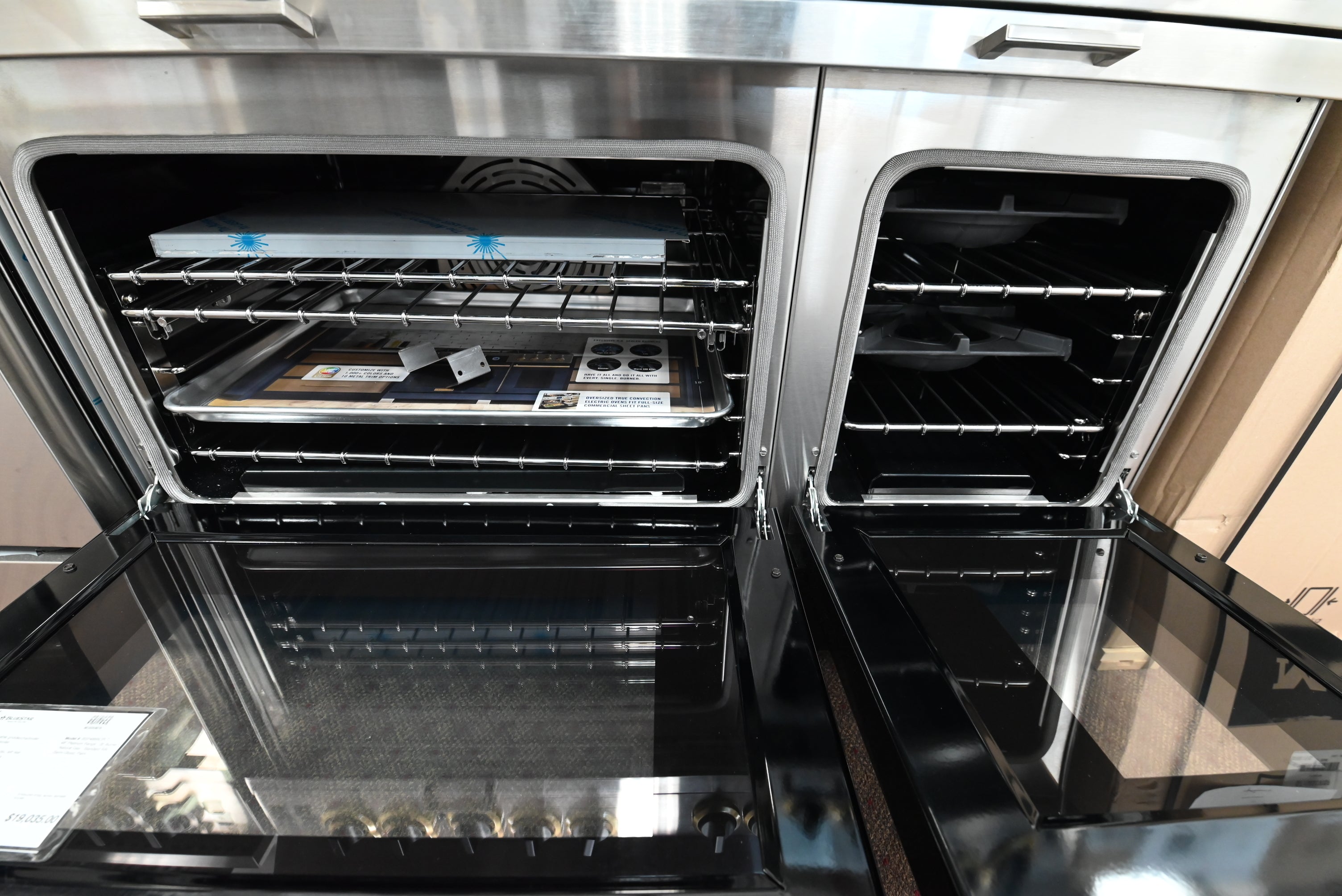 BlueStar 48 range showing open twin convection doors and commercial cast iron grates