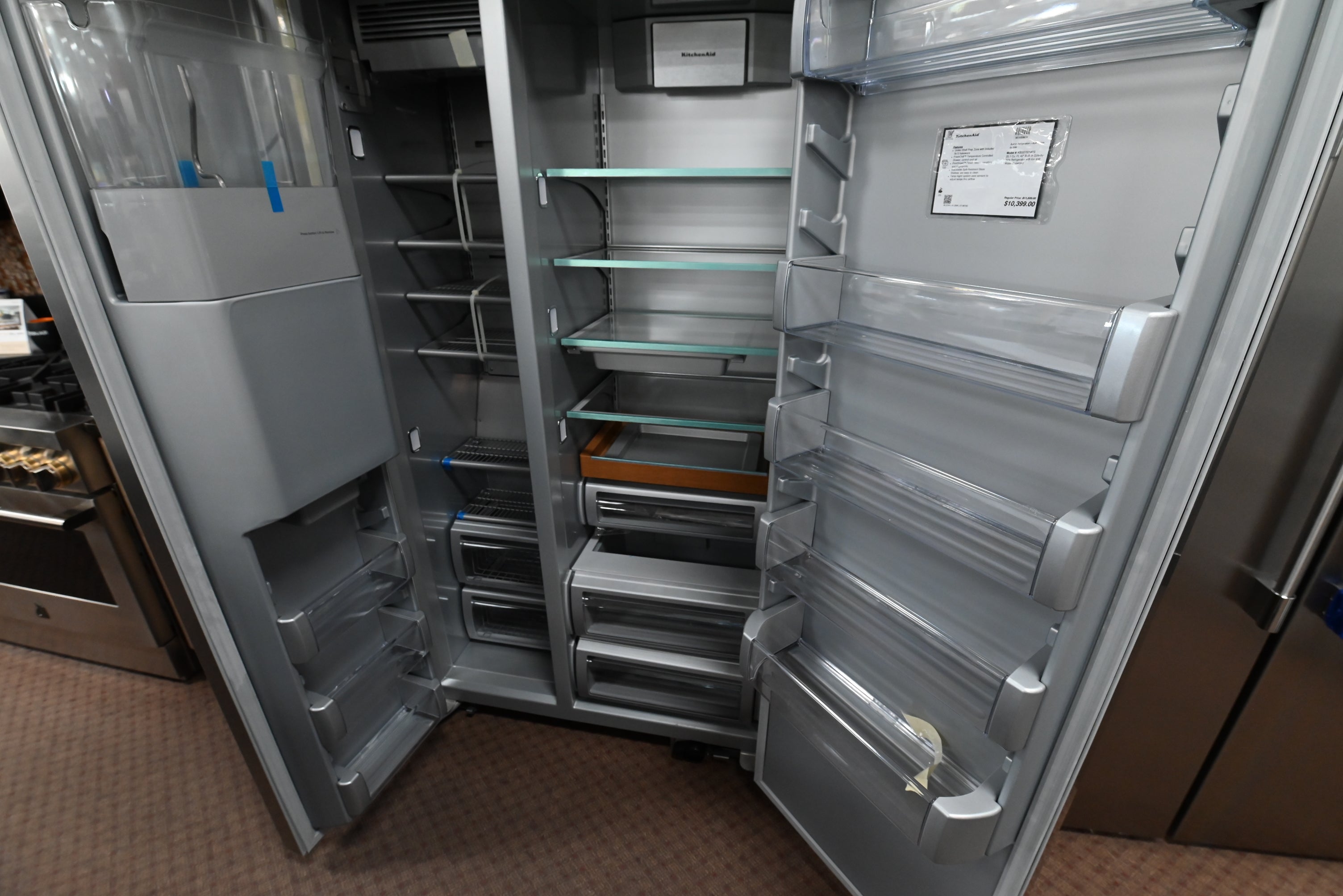 Luxury professional 42 inch built in refrigerator open doors showing platinum colored interior and prep zone