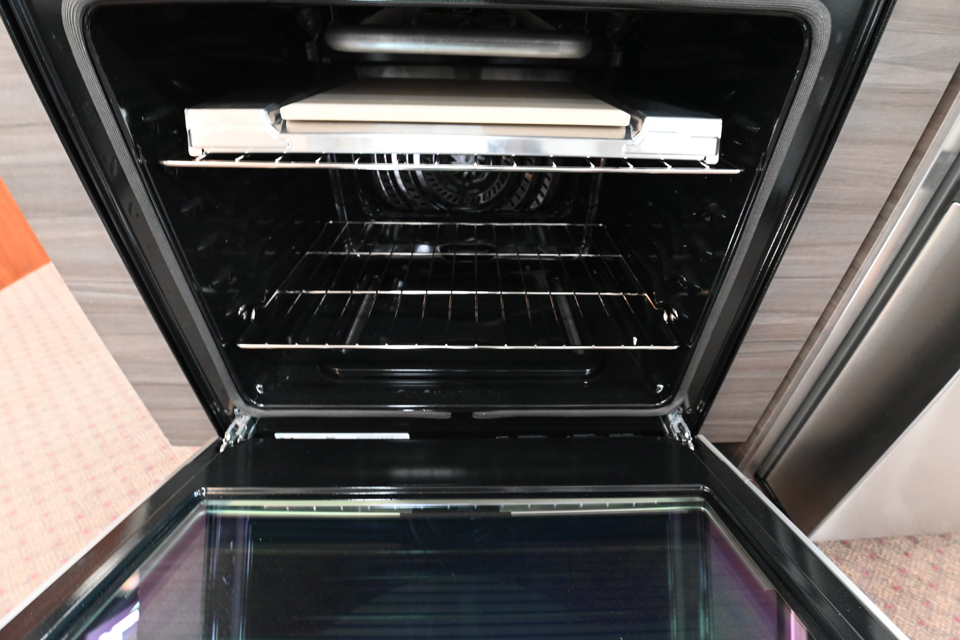 Close up view of the 5 burner gas cooktop with continuous cast iron grates and center griddle on a Frigidaire GCFG3070BF range