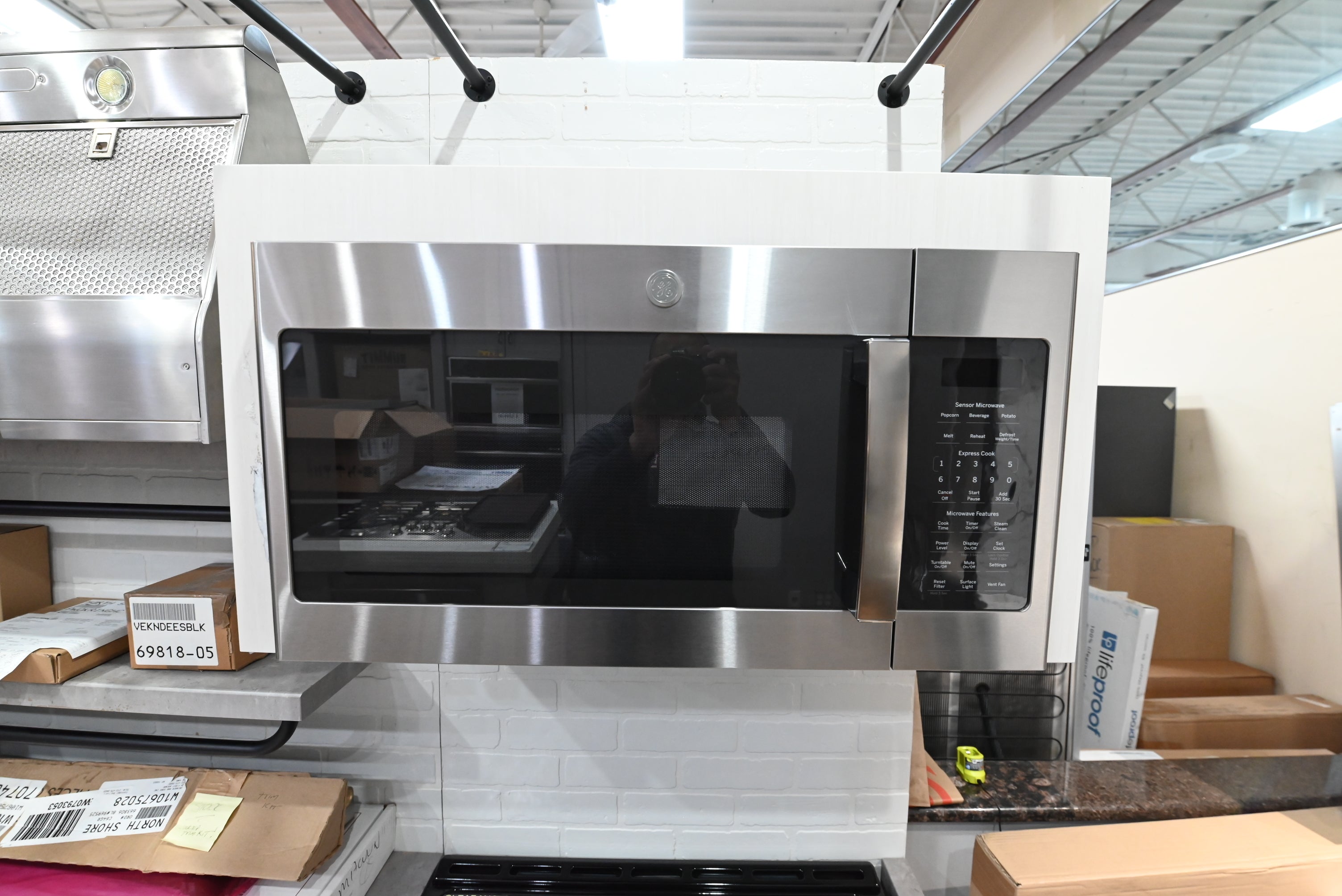 GE JVM7195SKSS 30 inch over the range microwave oven in brushed stainless steel straight front profile view