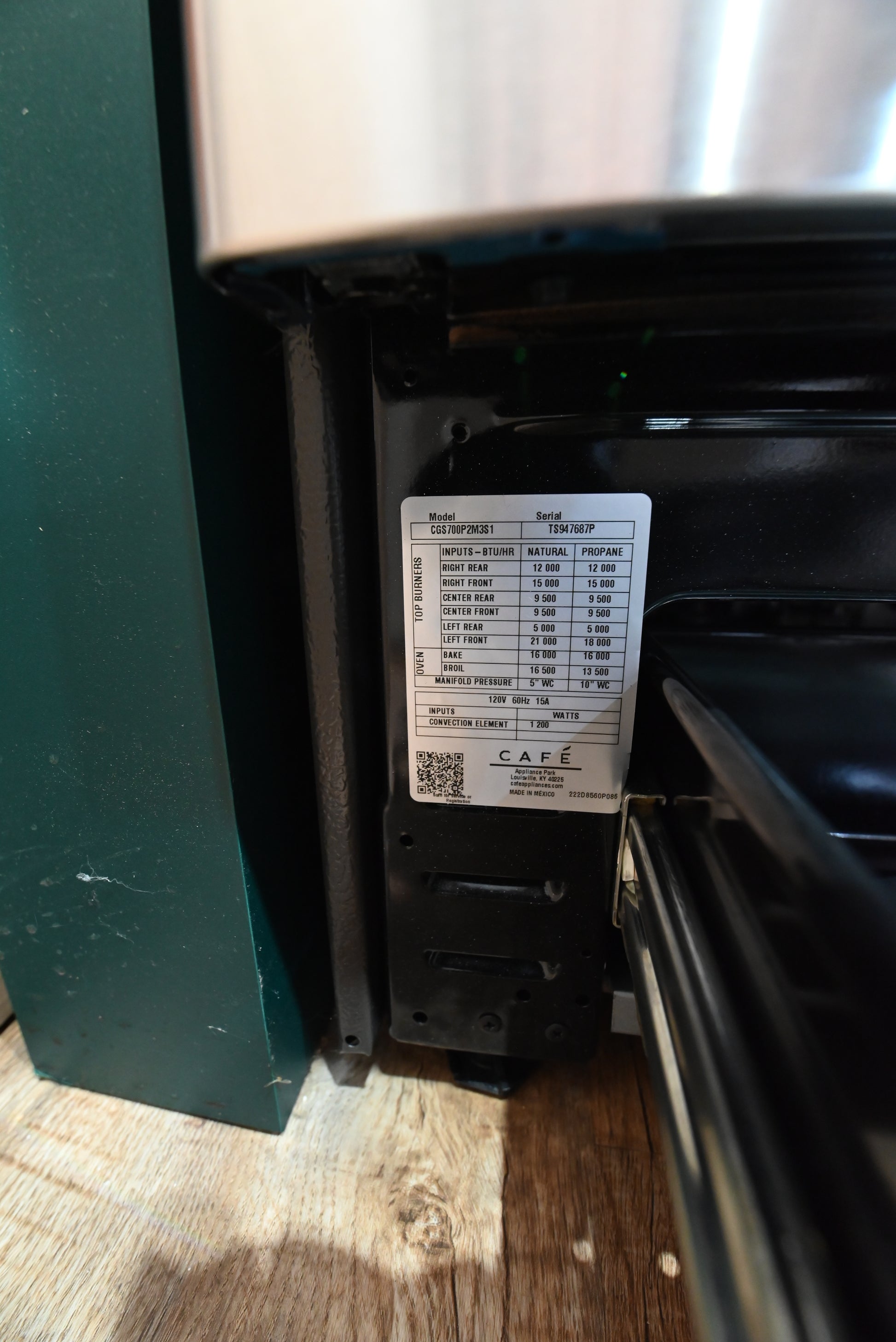 Cafe smart gas range showing open true convection oven door and continuous grates