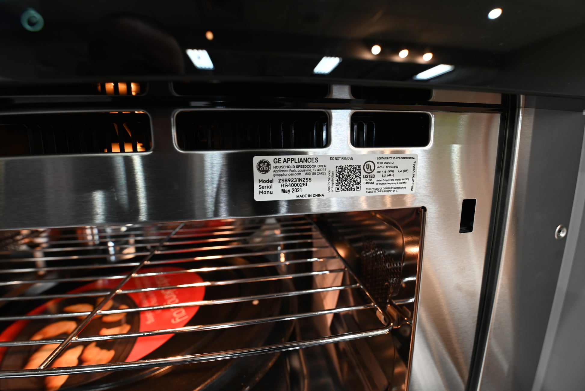 Monogram 30 inch speed oven installed in luxury kitchen cabinetry above a matching 30 inch warming drawer