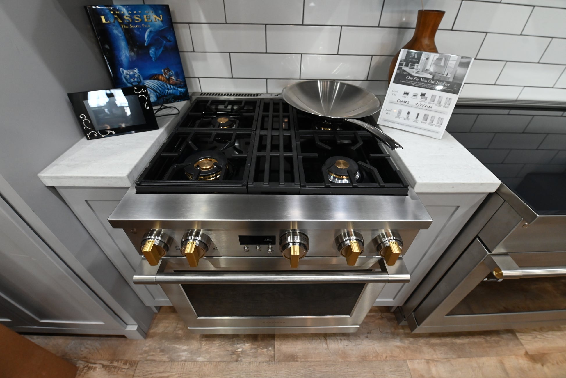 Close up view of the four gas burners and heavy-duty reversible wok grates on a 30 inch Monogram range
