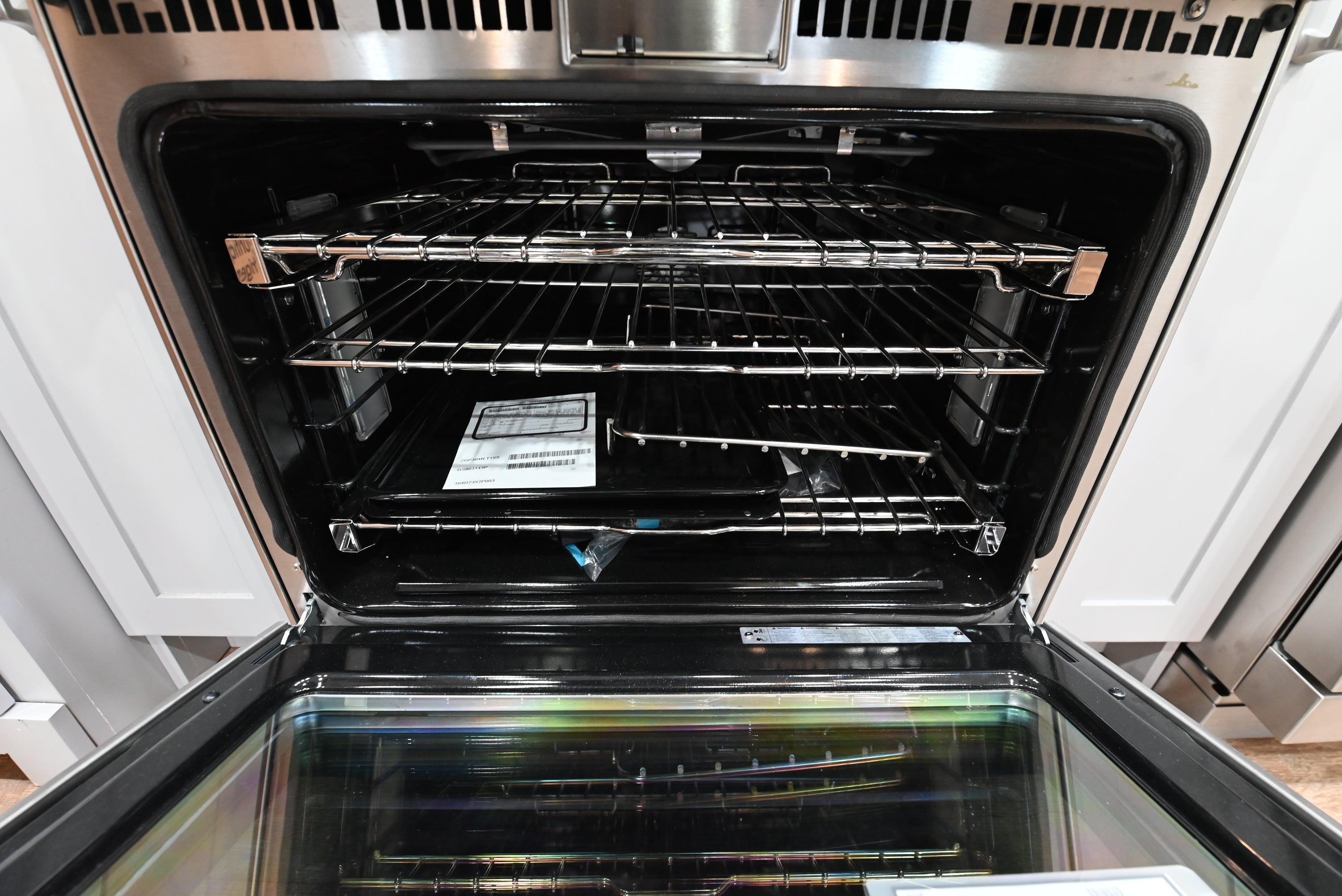 Modern luxury kitchen layout with a built-in 30 inch Monogram ZGP304NTSS stainless steel gas range