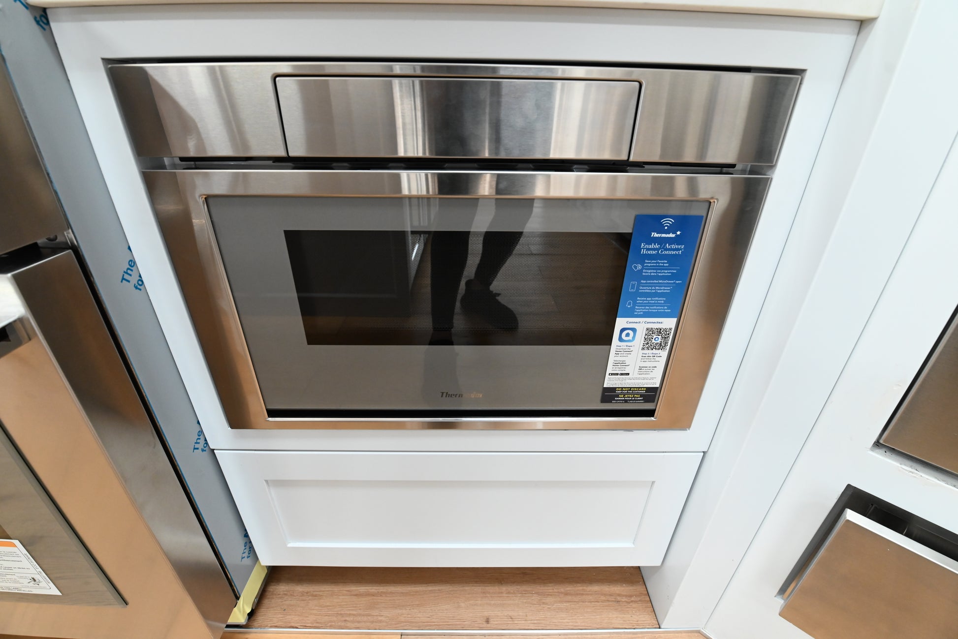 Luxury 24 inch drawer microwave open under counter showing spacious internal cavity