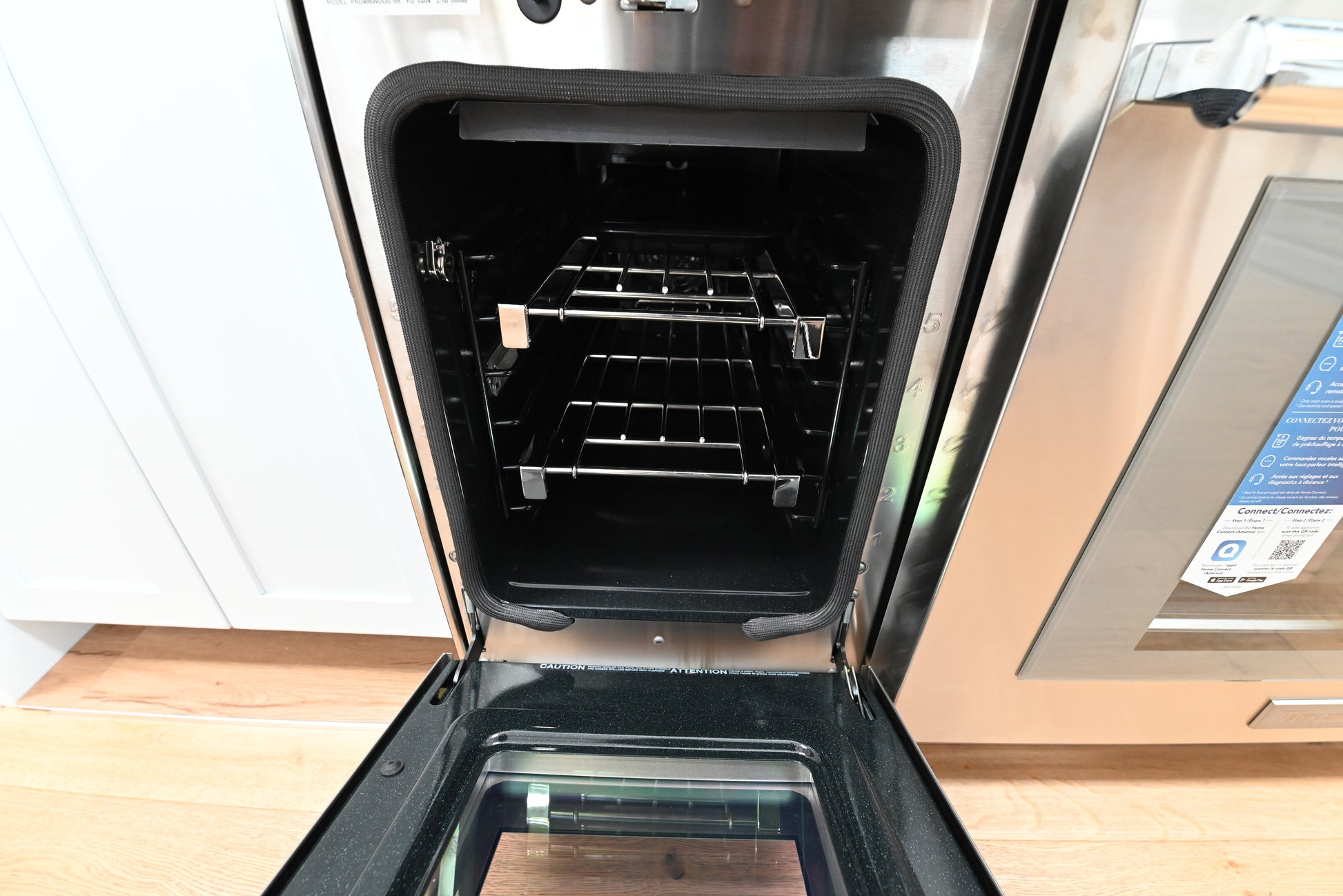 Thermador 48 inch double oven range showing open convection doors and lit touch screen