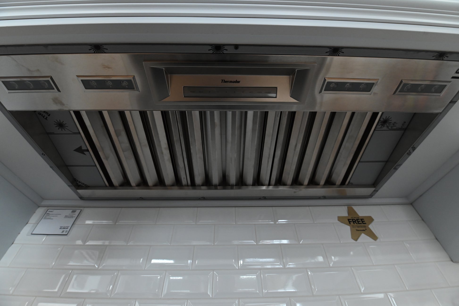 Luxury 48 inch custom cabinet hood liner looking up showing stainless steel commercial baffle filters