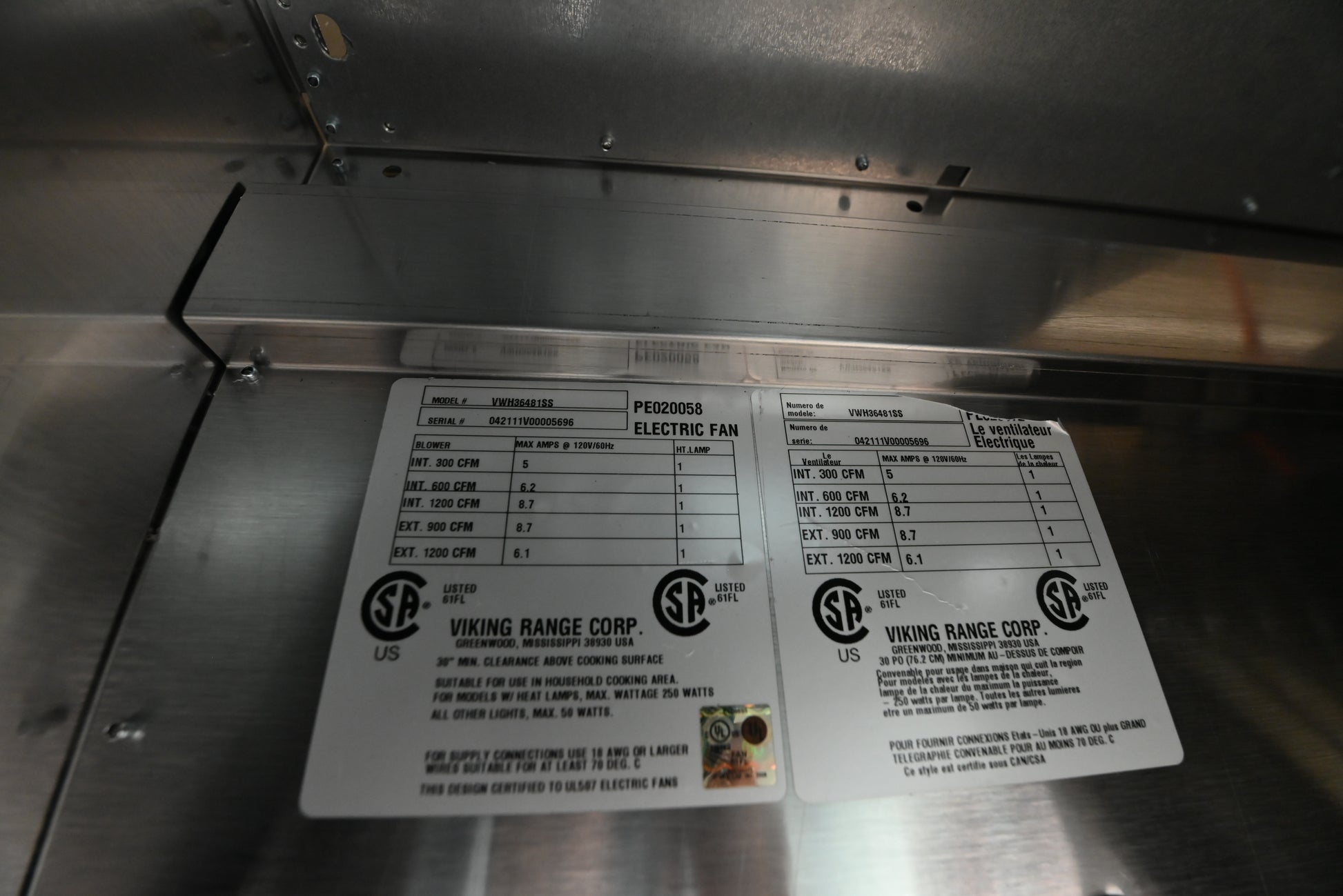 Viking 36 professional wall hood close up showing under rim controls and food warming heat lamp socket