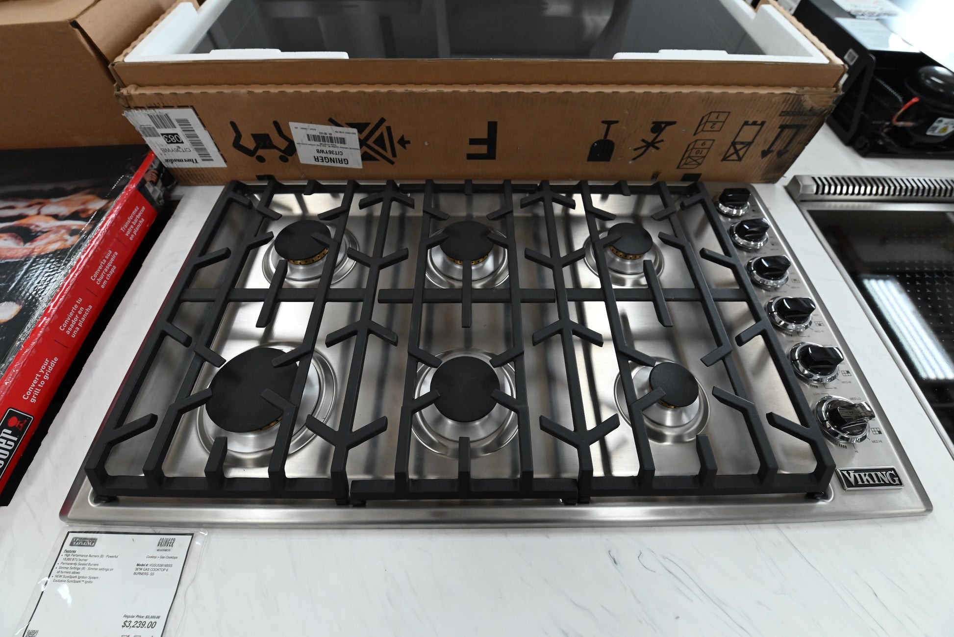 Luxury 36 inch Viking gas cooktop layout showing six sealed burners and heavy cast iron continuous grates