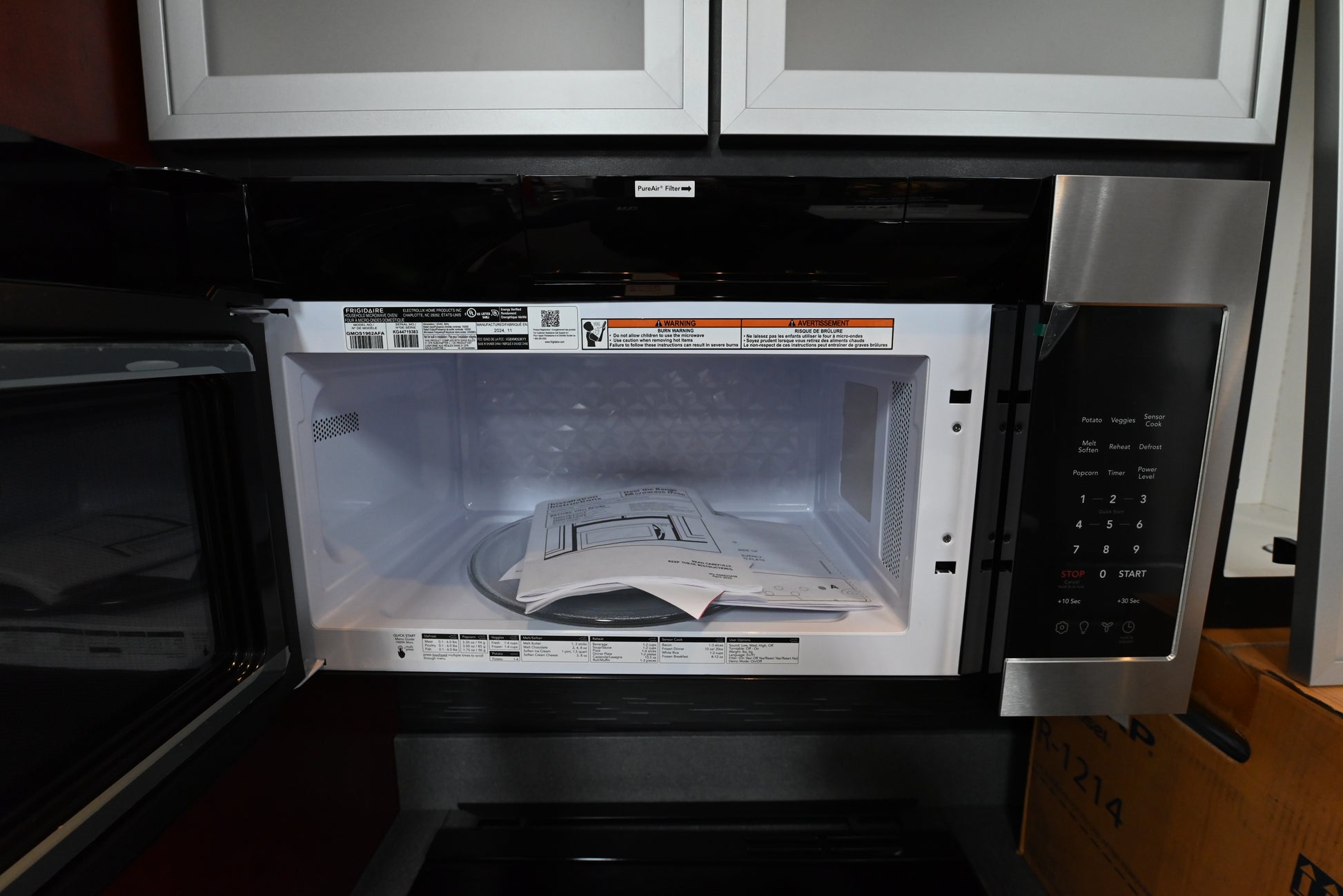 Luxury convection over the range microwave open showing clean stainless steel interior and baking rack