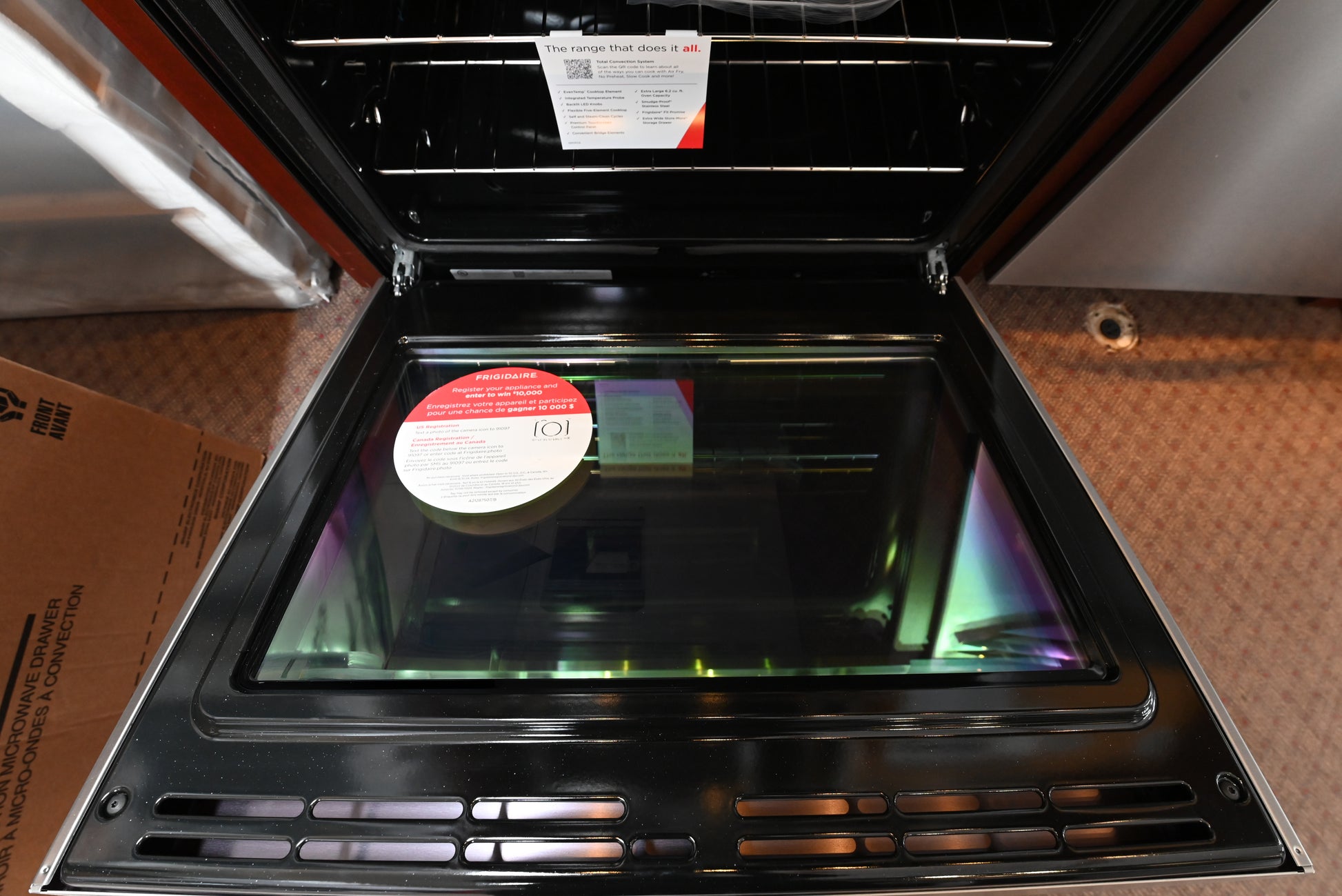 Frigidaire Gallery electric range oven open showing multi rack total convection layout and rear touch controls