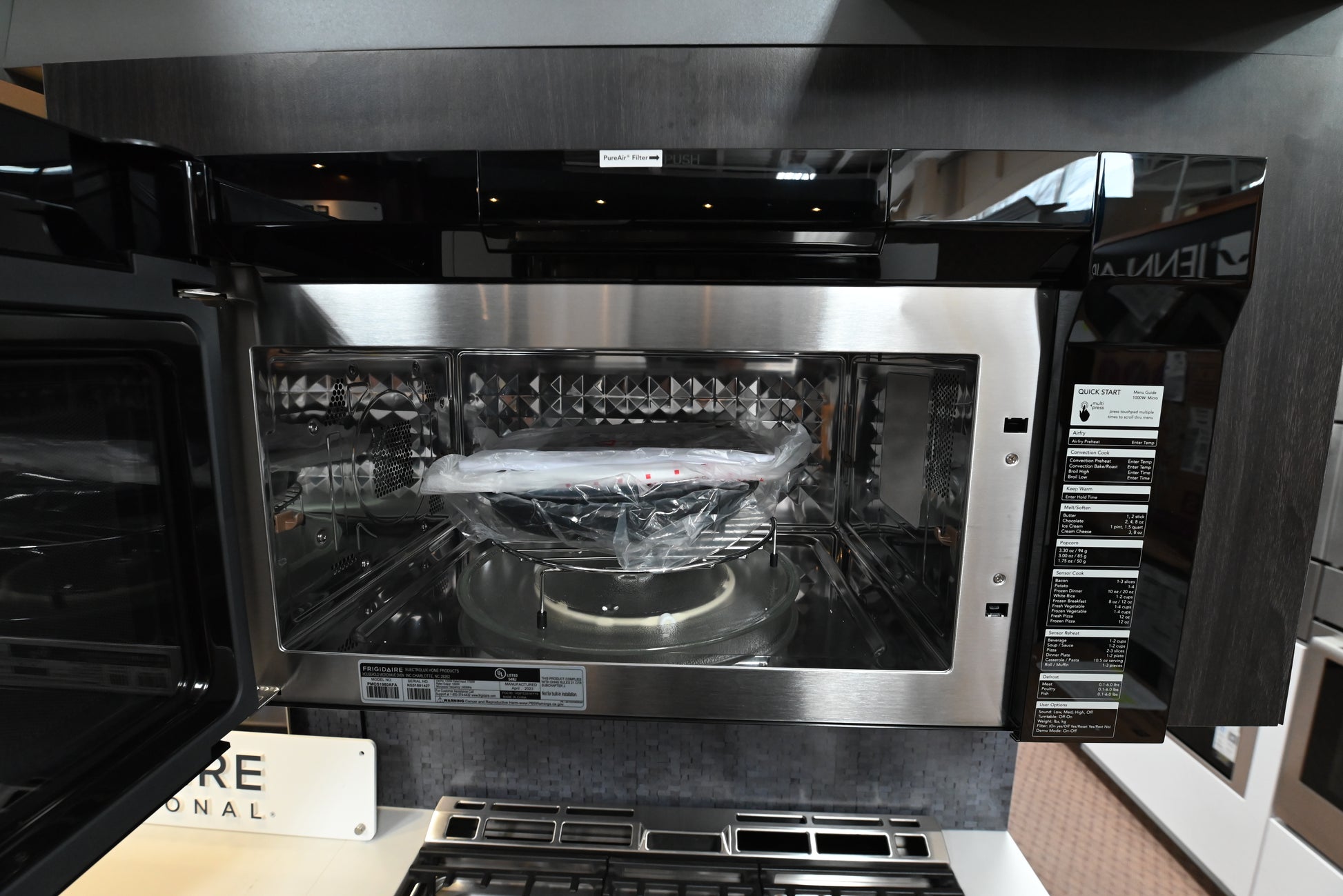 Luxury convection microwave open looking inside showing stainless steel interior racks and glass turntable