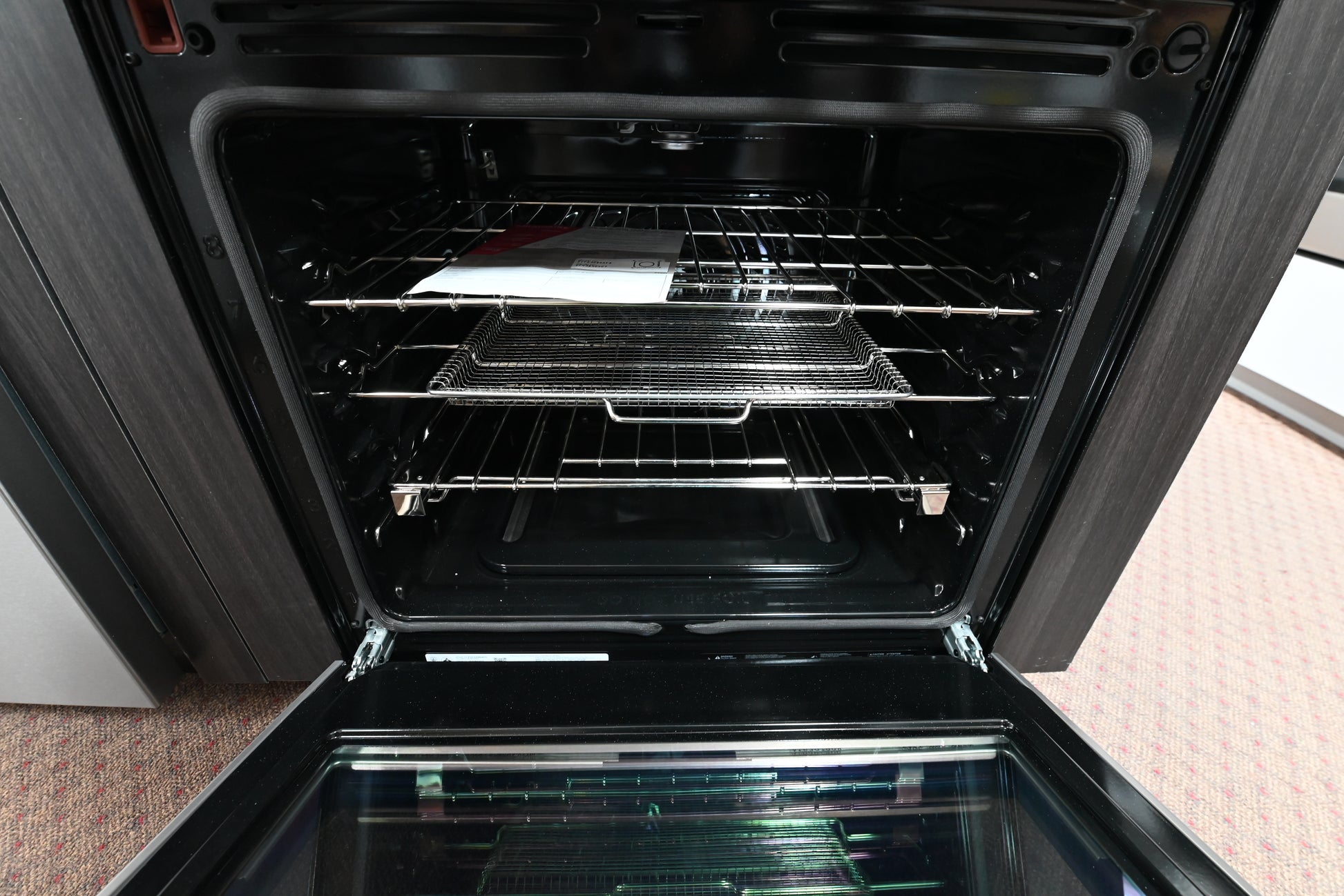 Frigidaire Pro gas range oven open showing air fry tray premium glide rack and backlit LED knobs