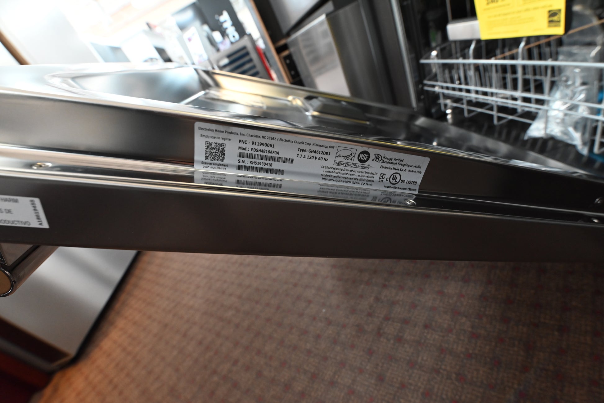 Frigidaire Pro 24 inch dishwasher installed flush under a dark charcoal quartz kitchen countertop