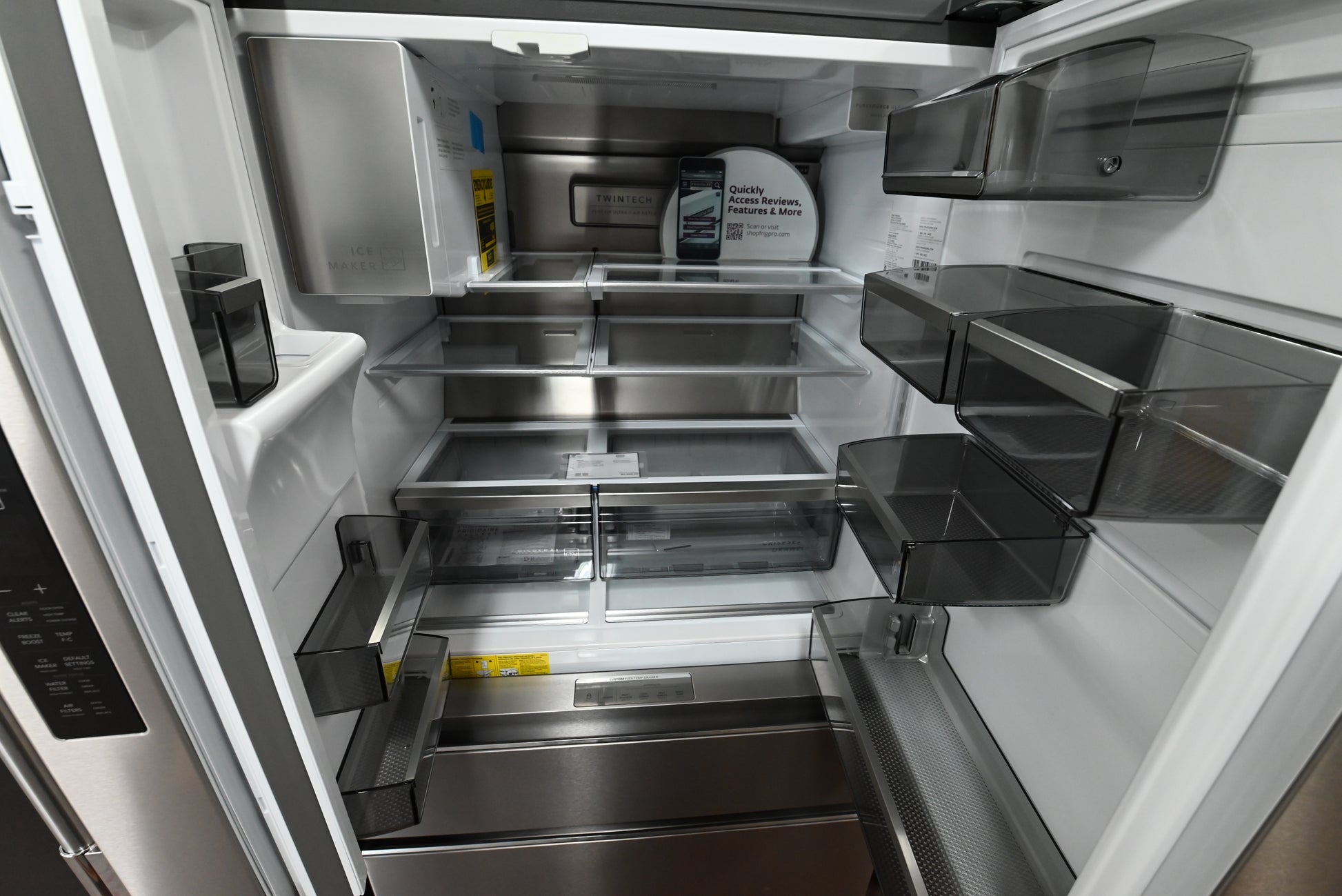 Luxury counter depth kitchen refrigerator showing open doors with LED lighting space wise shelves and custom flex temp drawe