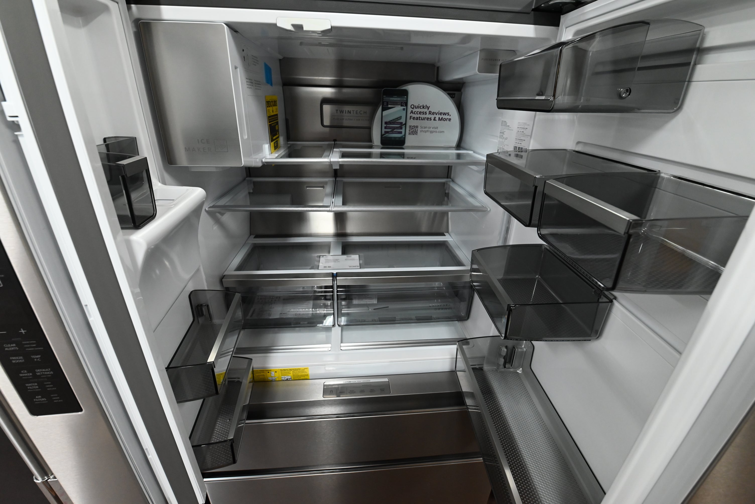 Luxury counter depth kitchen refrigerator showing open doors with LED lighting space wise shelves and custom flex temp drawe